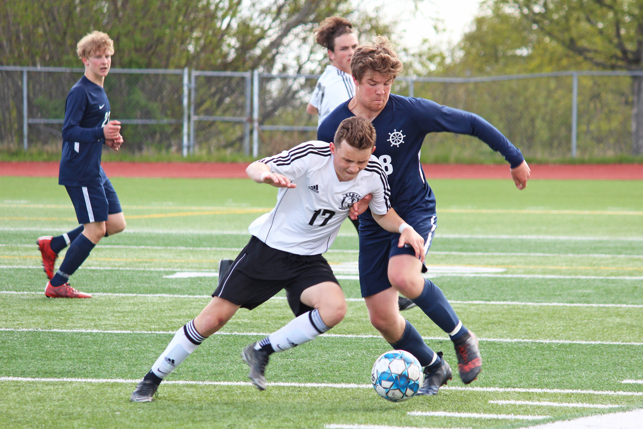 Homer’s Phinny Weston (right) and Kenai’s Travis Verkuilen battle for the ball during the championship boys soccer game of the Peninsula Conference Tournament on Saturday, May 18, 2019 at Homer High School in Homer, Alaska. The Mariners won 1-0. (Photo by Megan Pacer/Homer News)