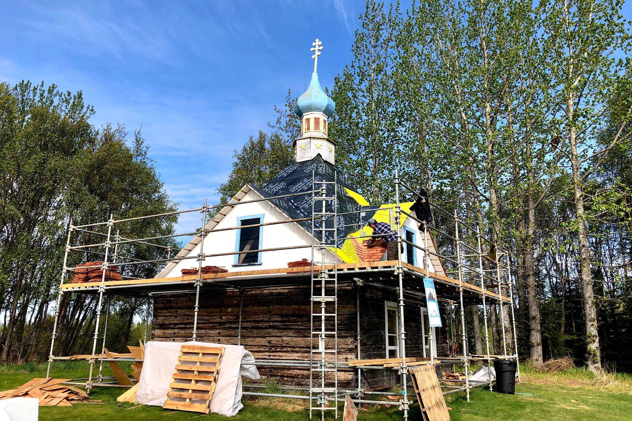 John Wachtel, a former National Parks Service employee, places new cedar shingles on the roof of the Saint Nicholas Memorial Chapel as part of new restorative efforts, on Tuesday, May 21, 2019, in Old Town Kenai, Alaska. (Photo by Victoria Petersen/Peninsula Clarion)