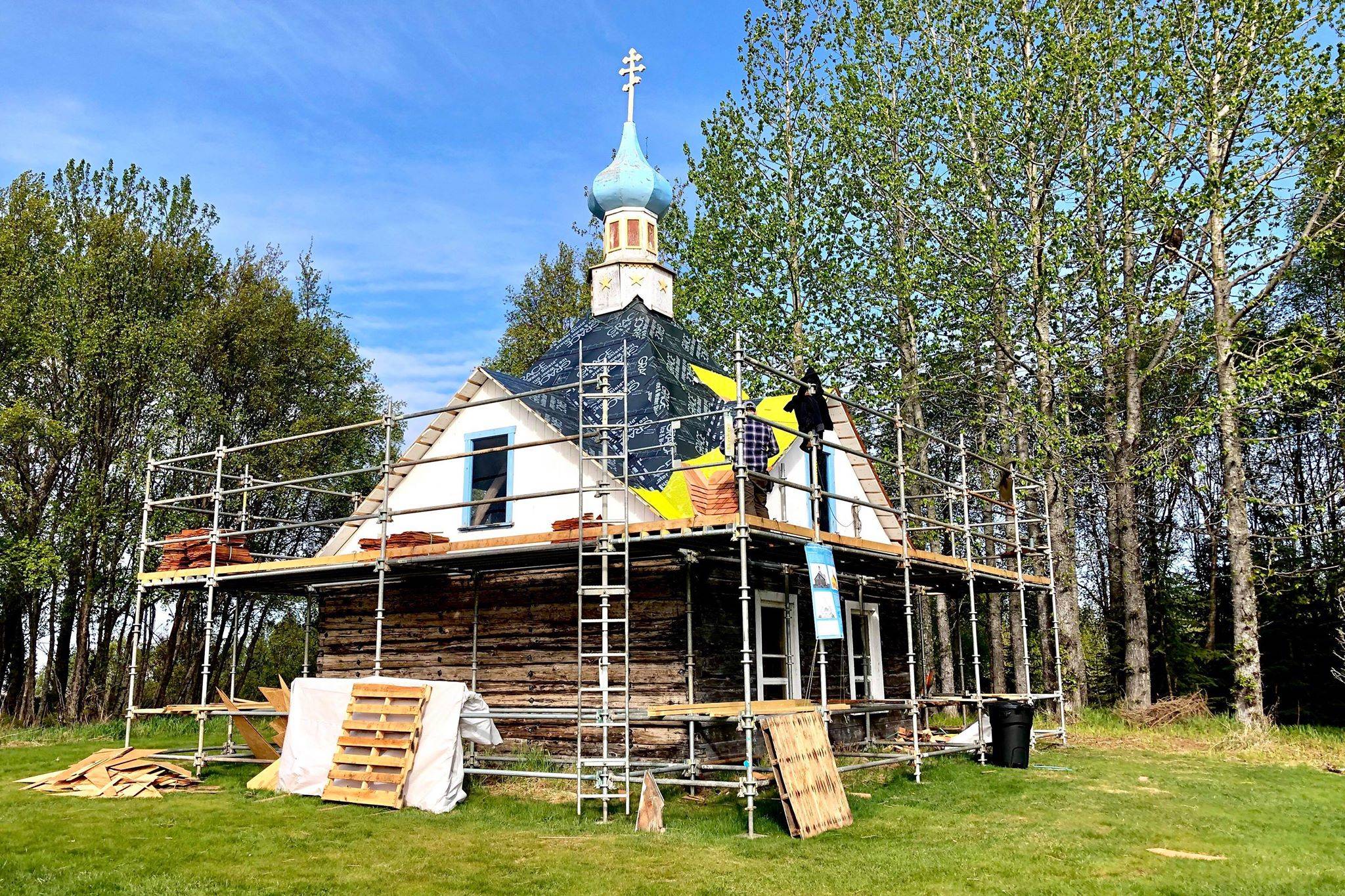 John Wachtel, a former National Parks Service employee, places new cedar shingles on the roof of the Saint Nicholas Memorial Chapel as part of new restorative efforts, on Tuesday, May 21, 2019, in Old Town Kenai, Alaska. (Photo by Victoria Petersen/Peninsula Clarion)