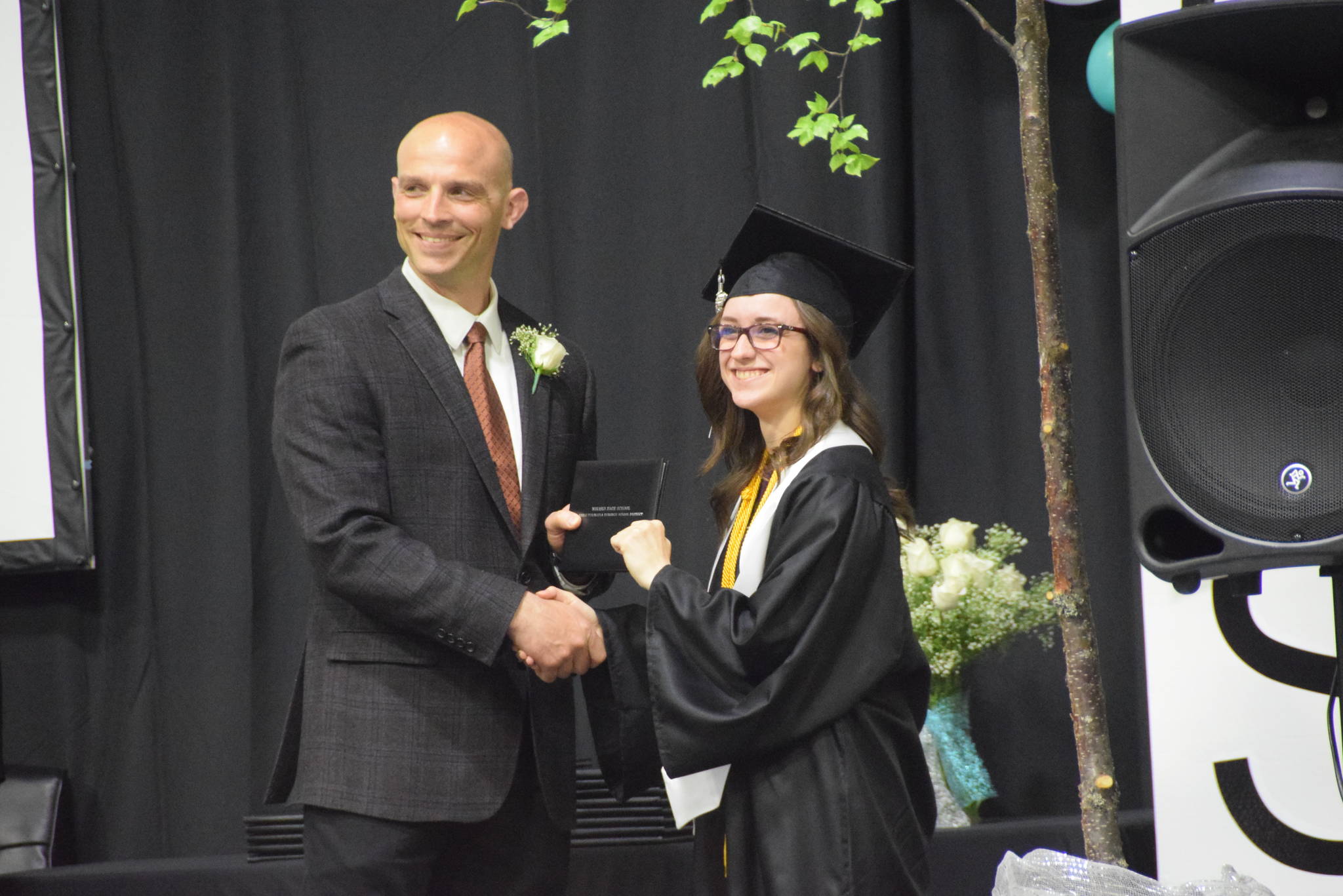 Carlee Rizzo receives her diploma from Principal Dan Carstens during the 2019 Nikiski High School graduation in Nikiski, Alaska on May 20, 2019. (Photo by Brian Mazurek/Peninsula Clarion)