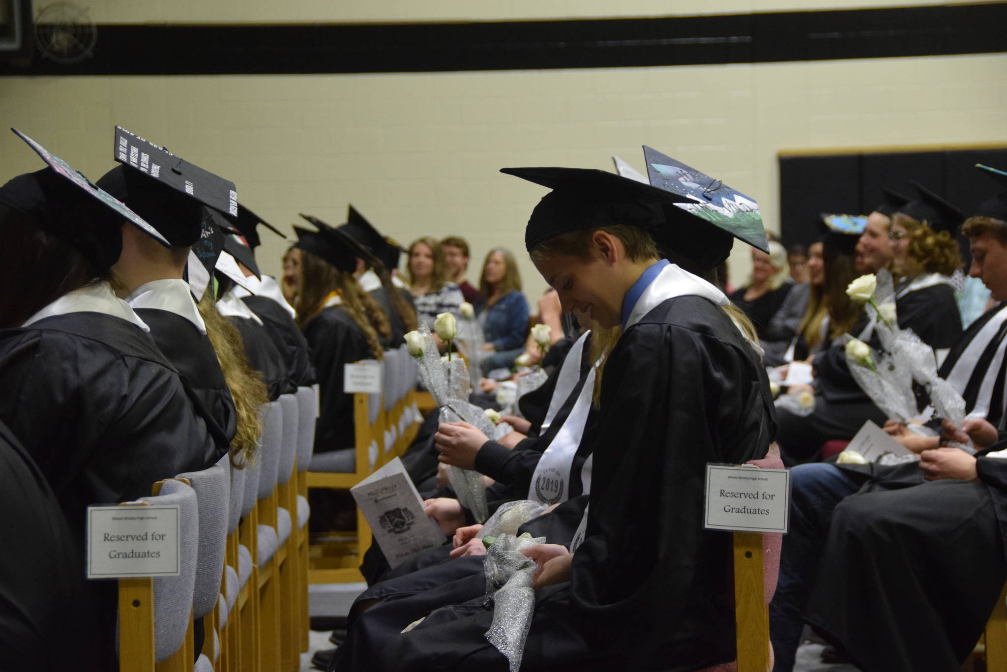 Abigail Bystedt and the other graduates sit in anticipation during the 2019 Nikiski High School graduation in Nikiski, Alaska on May 20, 2019. (Photo by Brian Mazurek/Peninsula Clarion)