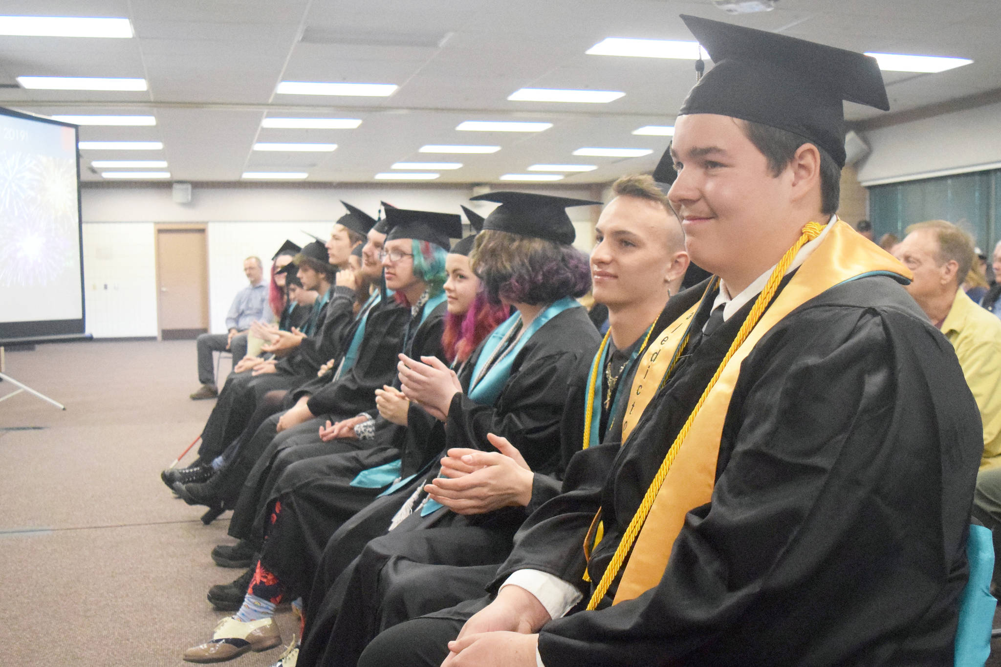 River City Academy valedictorian Steven Hunter Smith (front) awaits the presentation of diplomas Tuesday, May 21, 2019, at the Soldotna Regional Sports Complex in Soldotna, Alaska. (Photo by Joey Klecka/Peninsula Clarion)