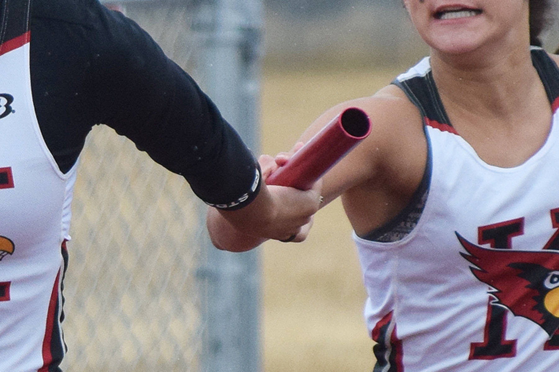 Kenai sophomore Alyssa Bucho (right) hands the baton off to senior teammate Tekaiya Rich in the girls 400-meter sprint relay April 27, 2019, at the Kenai Invitational at Ed Hollier Field. (Photo by Joey Klecka/Peninsula Clarion)