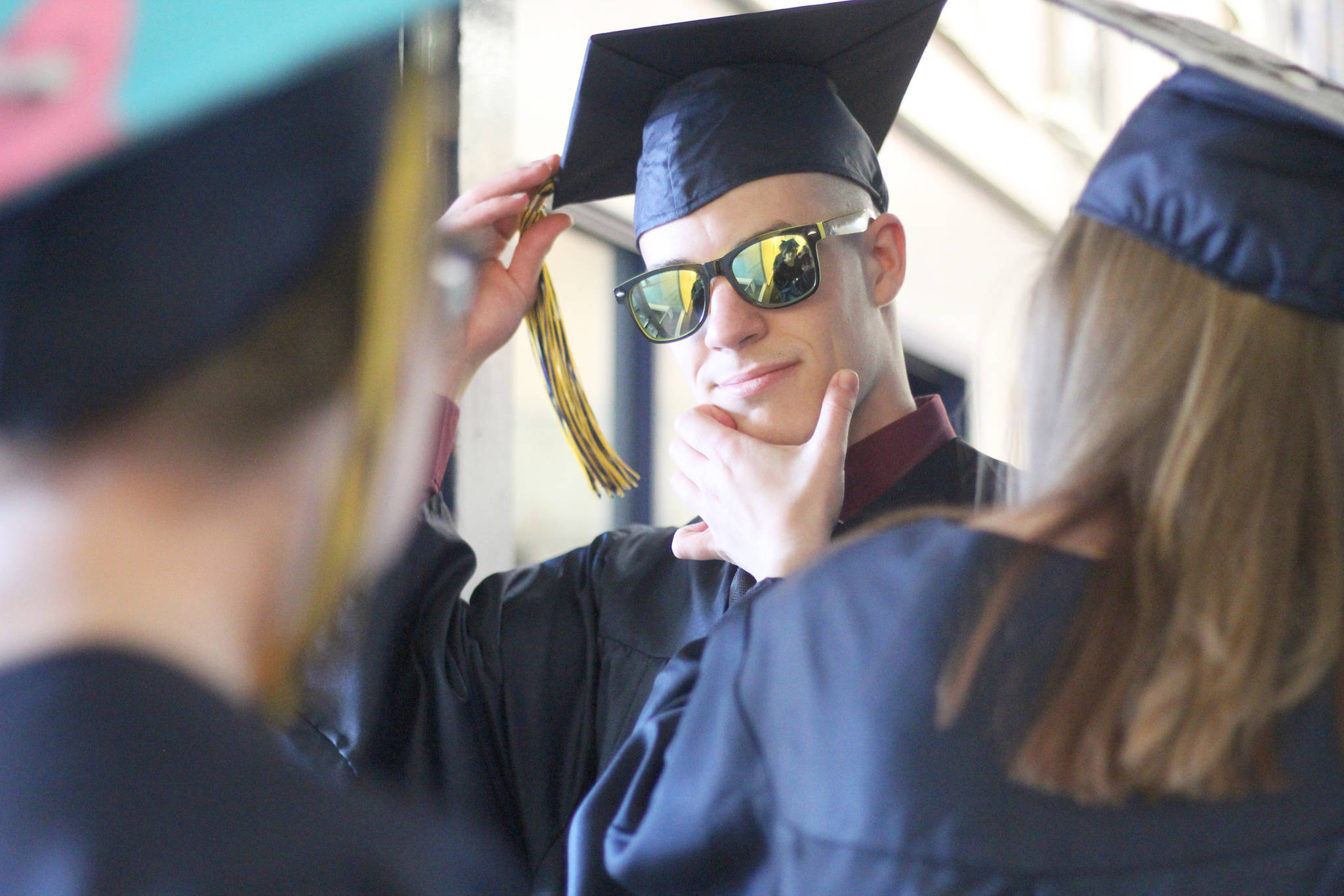 Isabella Koch helps Garrett Koch perfect the finishing touches before they walk in their graduation ceremony Tuesday, May 21, 2019 at Ninilchik School in Ninilchik, Alaska. They are two of four total Ninilchik graduates this year. (Photo by Megan Pacer/Homer News)