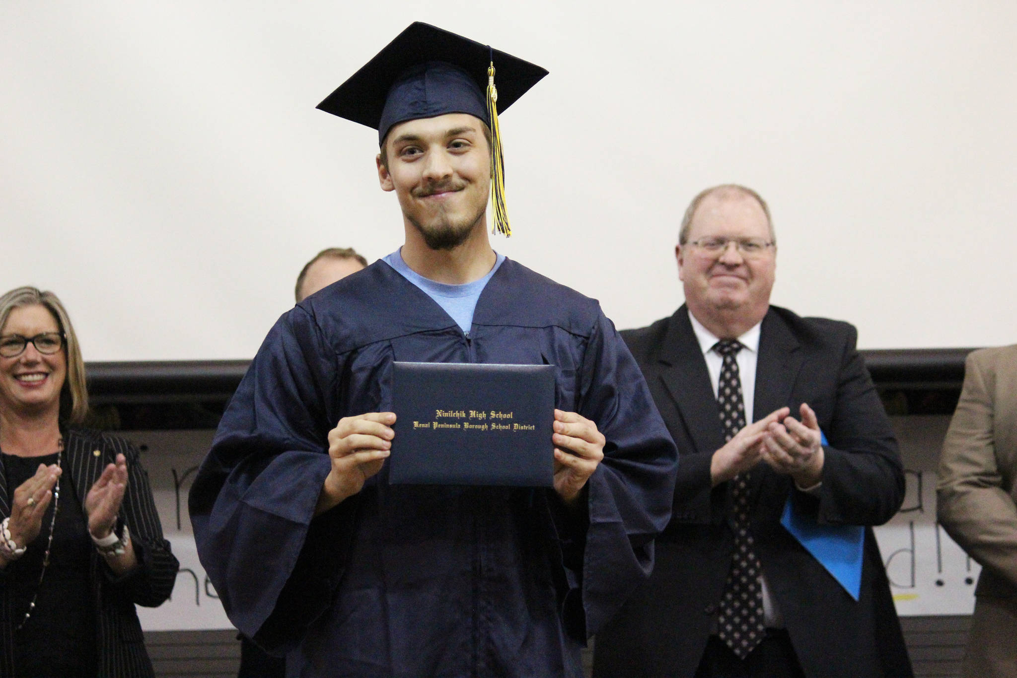 Ninilchik School graduate Jacob Shell receives his diploma during a Tuesday, May 21, 2019 graduation ceremony at the school in Ninilchik, Alaska. (Photo by Megan Pacer/Homer News)