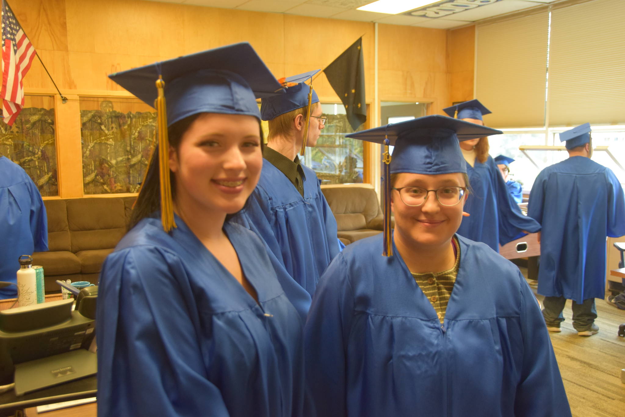 Paige Cruse, left, and Hope Hoadley, right, smile for the camera during the Kenai Alternative High School 2019 graduation in Kenai, Alaska on May 22, 2019. (Photo by Brian Mazurek/Peninsula Clarion)