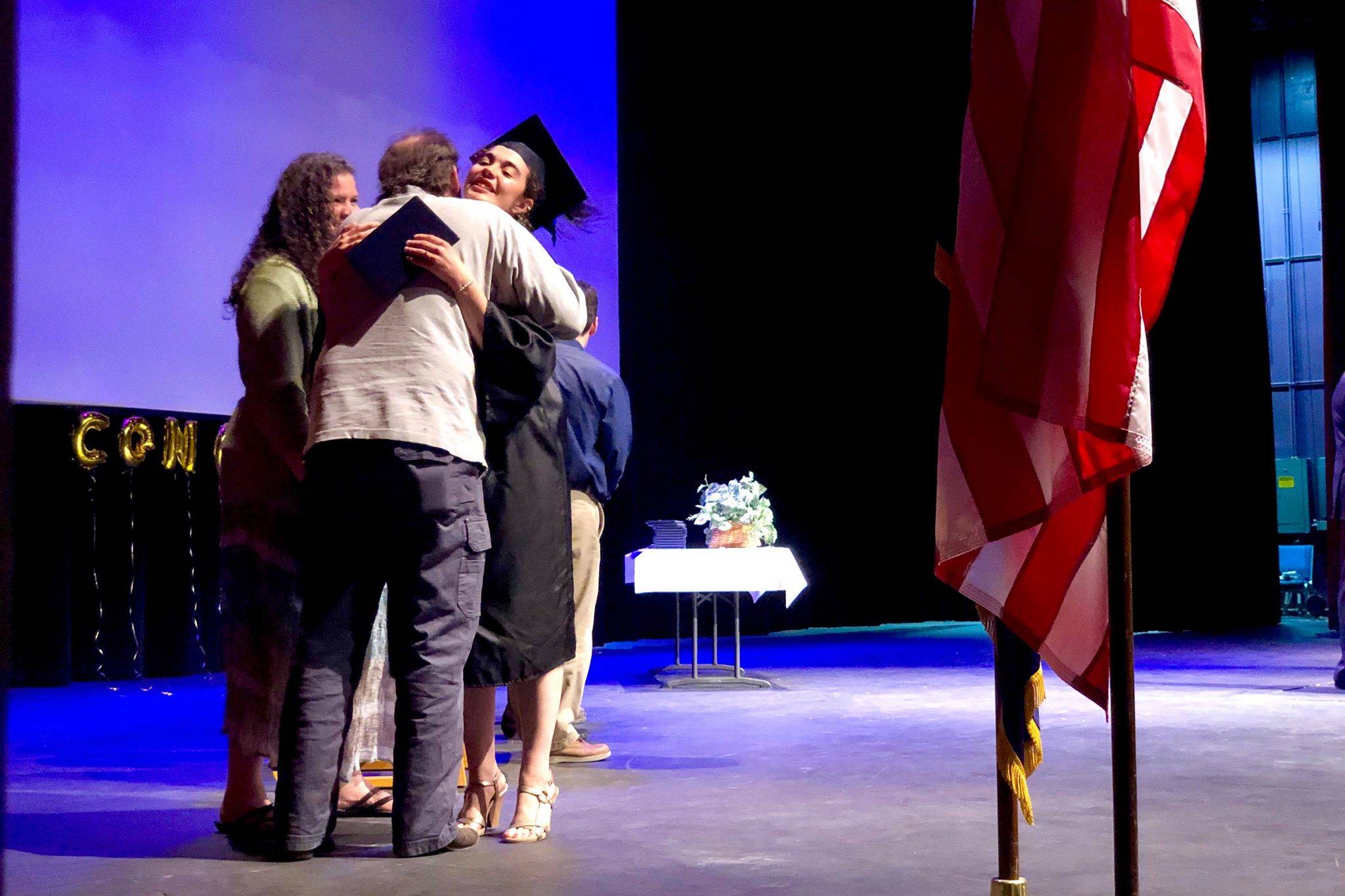 Graduate Emerald Miller receives her high school diploma from her parents at the Kenai Peninsula Borough School District Connections home school program graduation ceremony, Thursday, May 23, 2019, in Soldotna, Alaska. (Photo by Victoria Petersen/Peninsula Clarion)                                Graduate Emerald Miller receives her high school diploma from her parents at the Kenai Peninsula Borough School District Connections home-school program graduation ceremony, Thursday, May 23, 2019, in Soldotna, Alaska. (Photo by Victoria Petersen/Peninsula Clarion)