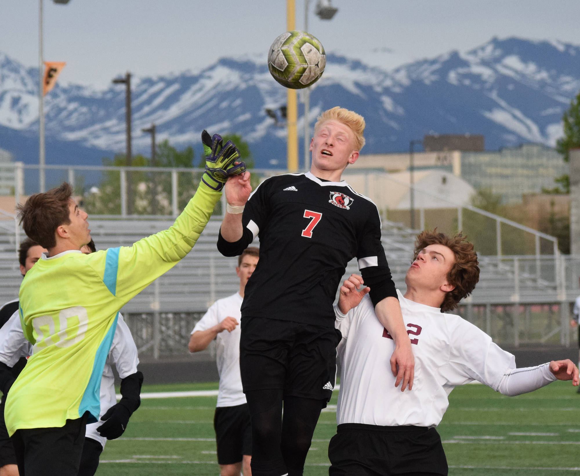 Kenai’s Leif Lofquist gets his head on a ball against Grace Christian Thursday, May 23, 2019, at the Div. II state soccer championships at West High School. (Photo by Joey Klecka/Peninsula Clarion)