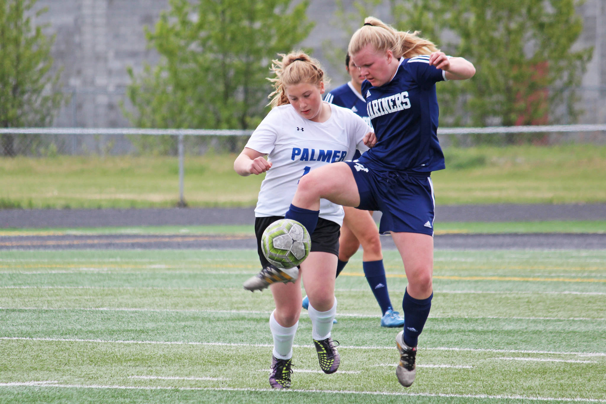 Homer’s Daisy Kettle battles for the ball with Palmer’s Avery Hill in a Friday, May 24, 2019 game during the Division II state soccer championship tournament at West Anchorage High School in Anchorage, Alaska. (Photo by Megan Pacer/Homer News)