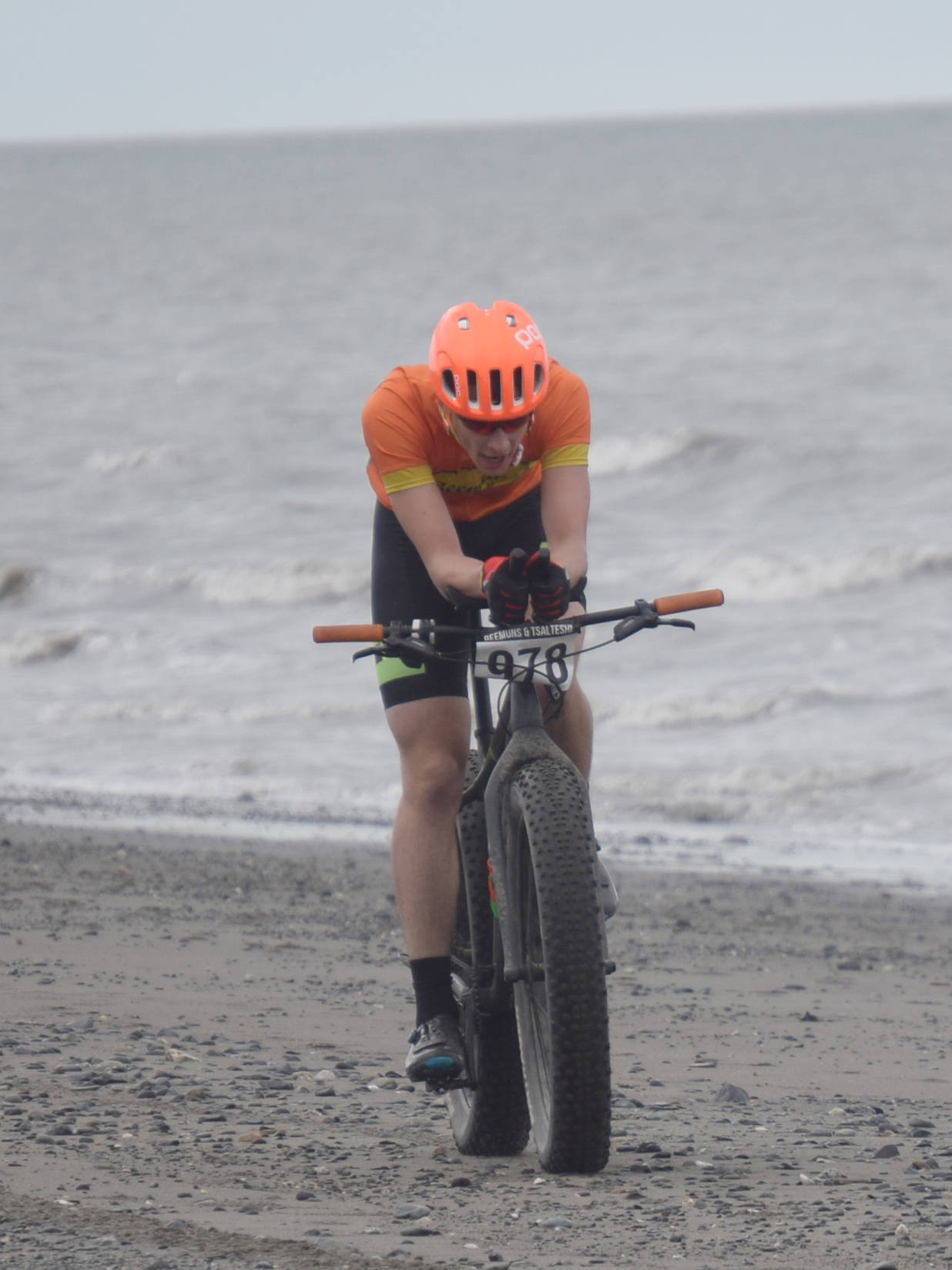 Tyle Owens rides to victory at the 10-mile bike of the Mouth to Mouth Wild Run and Ride on Monday, May 27, 2019, at the beach in Kenai, Alaska. (Photo by Jeff Helminiak/Peninsula Clarion)