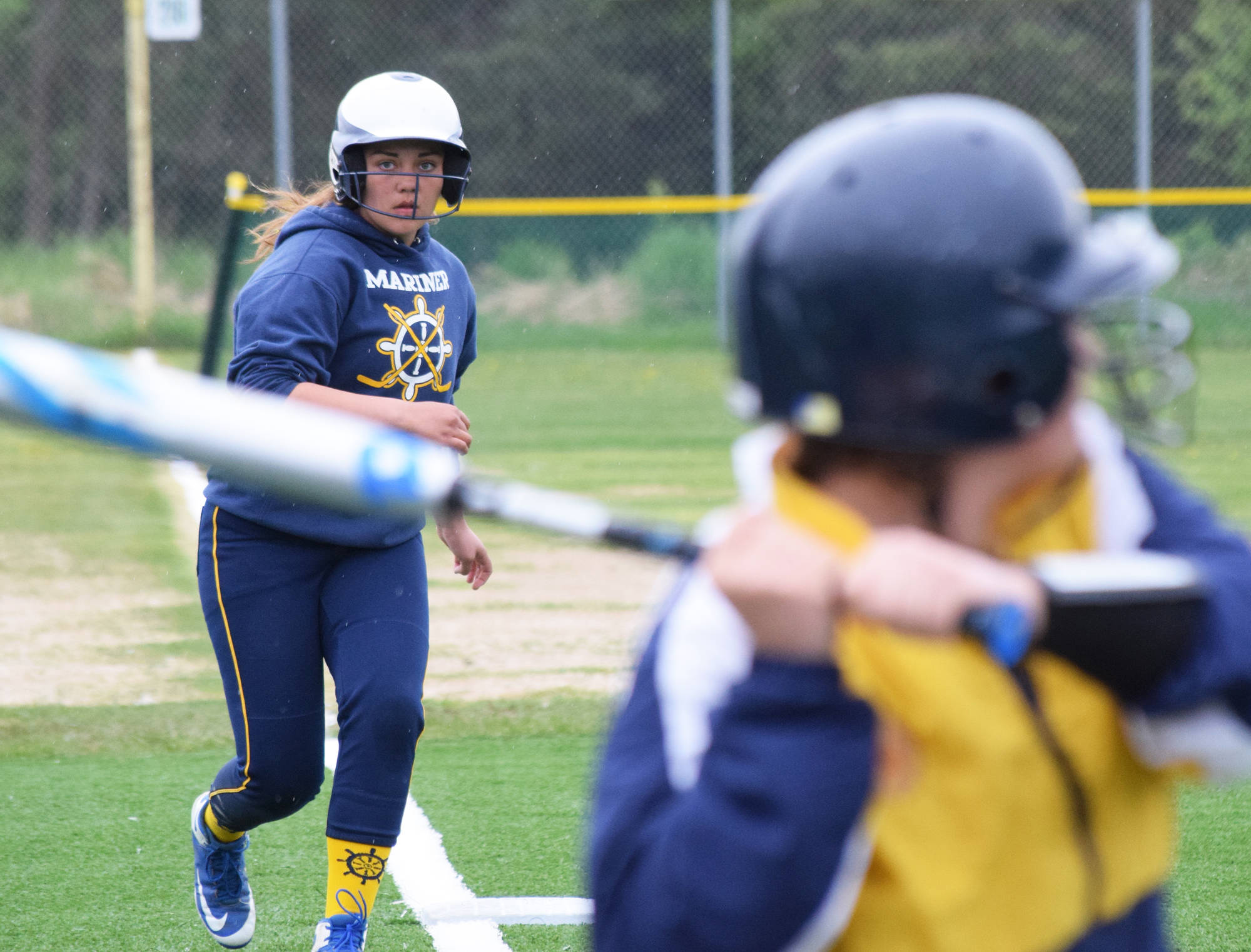 Homer’s Carleigh Nevak keeps an eye on a Mariners teammate against Hutchison, Thursday, May 30, 2019, at the Div. II state softball tournament at Cartee Fields in Anchorage, Alaska. (Photo by Joey Klecka/Peninsula Clarion)