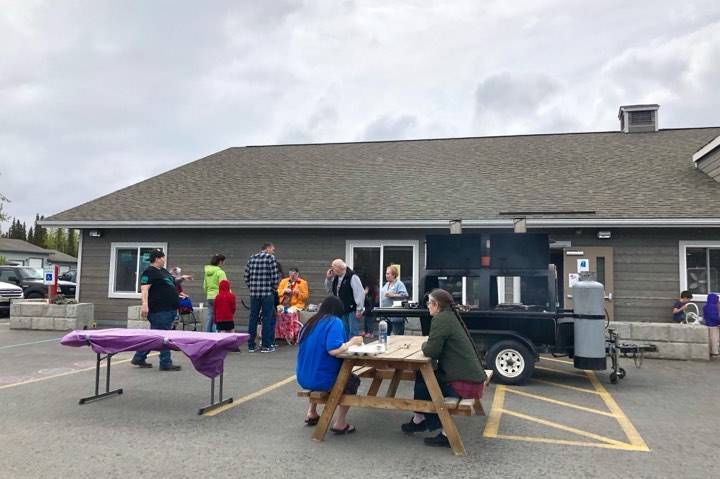 Residents eat brats and hot dogs during the Kenai Peninsula Food Bank Spring Festival and Fundraiser’s free community picnic, an event meant to thank the community, Friday, May 31, 2019, near Soldotna, Alaska. (Photo by Victoria Petersen/Peninsula Clarion)