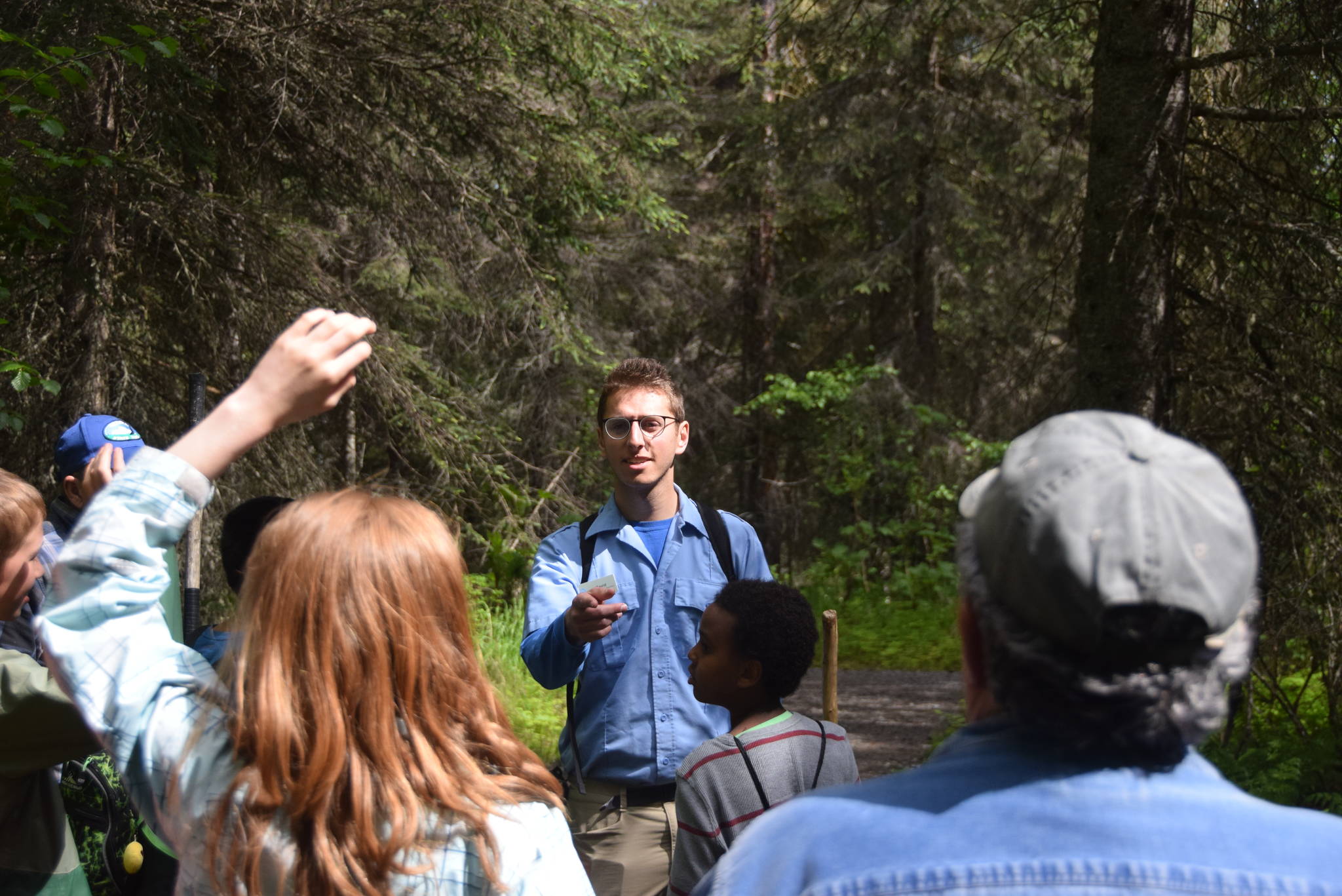 Environmental education intern David Fink answers questions from the hikers during a guided hike on Centennial Trail in the Kenai National Wildlife Refuge on June 1, 2019. (Photo by Brian Mazurek/Peninsula Clarion)