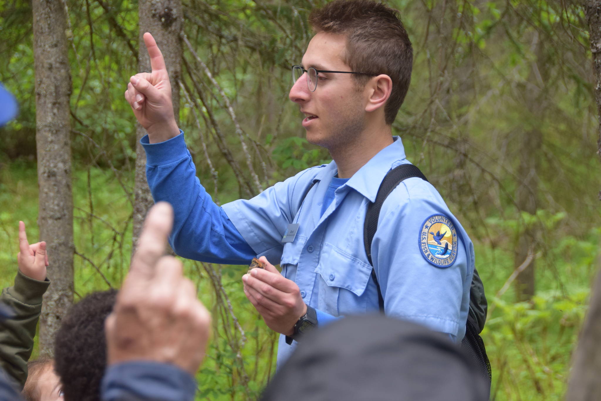 Environmental Education Intern David Fink teaches a trick for remembering the scientific name of the tinder conk mushroom (fomes fomentarius) during a guided hike on Centennial Trail in the Kenai National Wildlife Refuge on June 1, 2019. (Photo by Brian Mazurek/Peninsula Clarion)