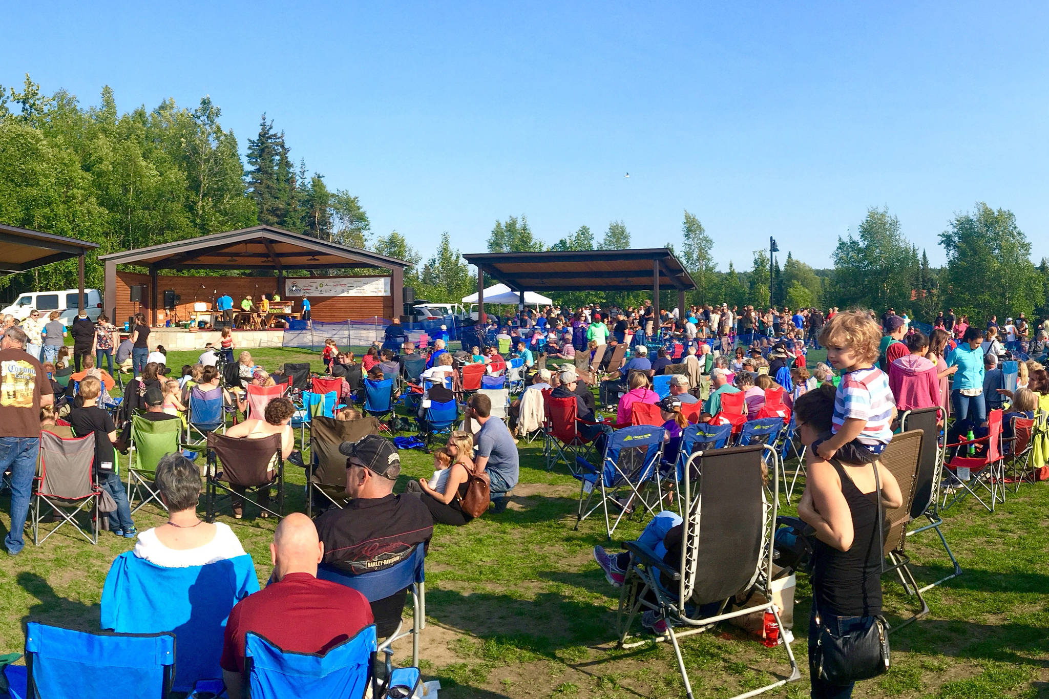 Concertgoers listen during one of the weekly concerts in the park, put on as part of the Levitt AMP Soldotna Music Series in Soldotna, Alaska, in the summer of 2017. (Photo courtesy Andrew Heuiser/Soldotna Chamber of Commerce)