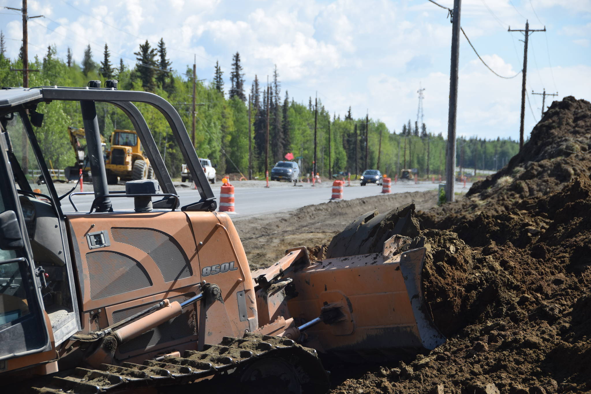 Construction crews excavate along the side of the Kenai Spur Highway in Soldotna, Alaska, on Tuesday, June 4, 2019. (Photo by Brian Mazurek/Peninsula Clarion)