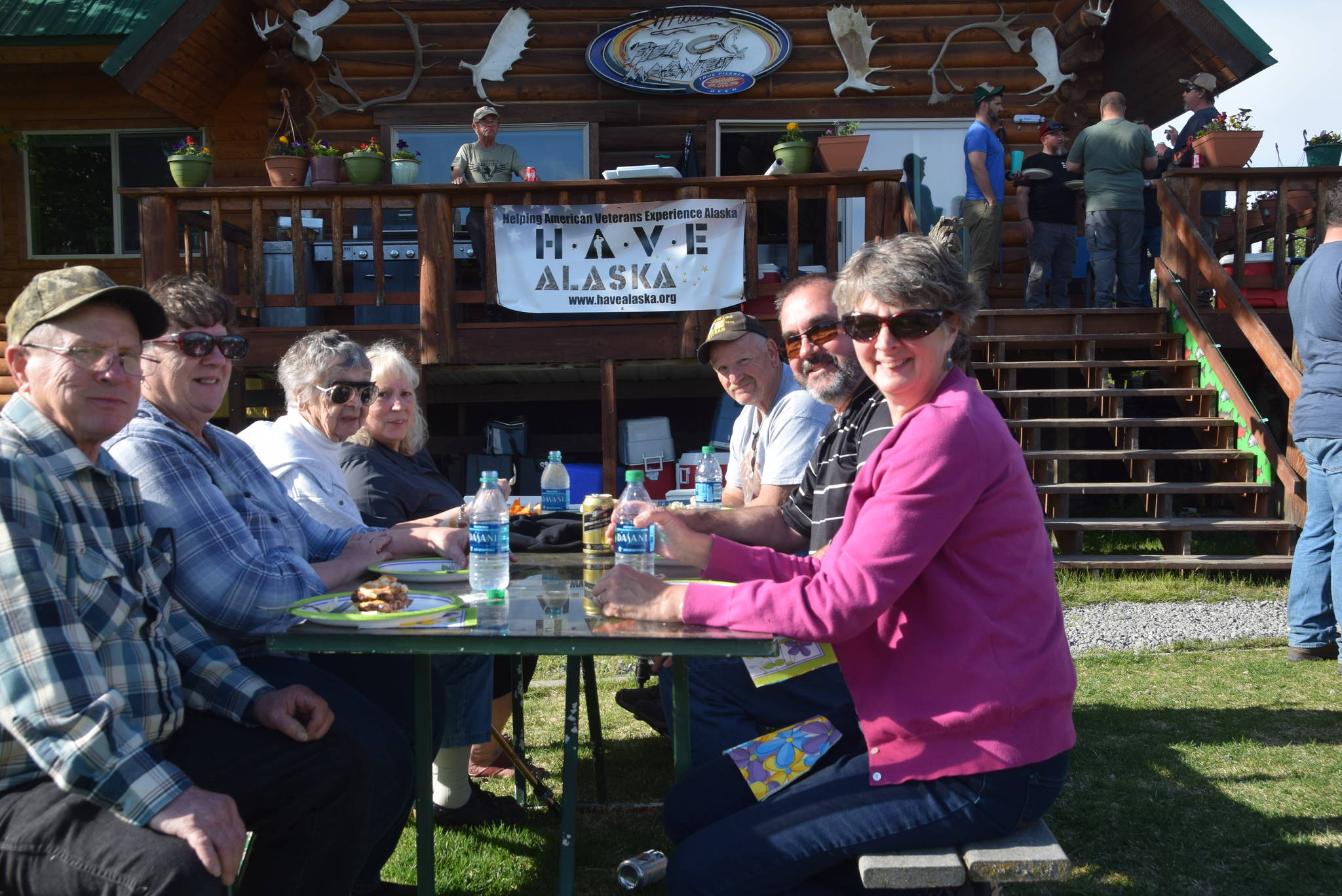 Veterans and volunteers enjoy a cookout together as part of HAVE-Alaska’s 2019 fishing trip in Soldotna, Alaska, on Wednesday, June 5, 2019. (Photo by Brian Mazurek/Peninsula Clarion)