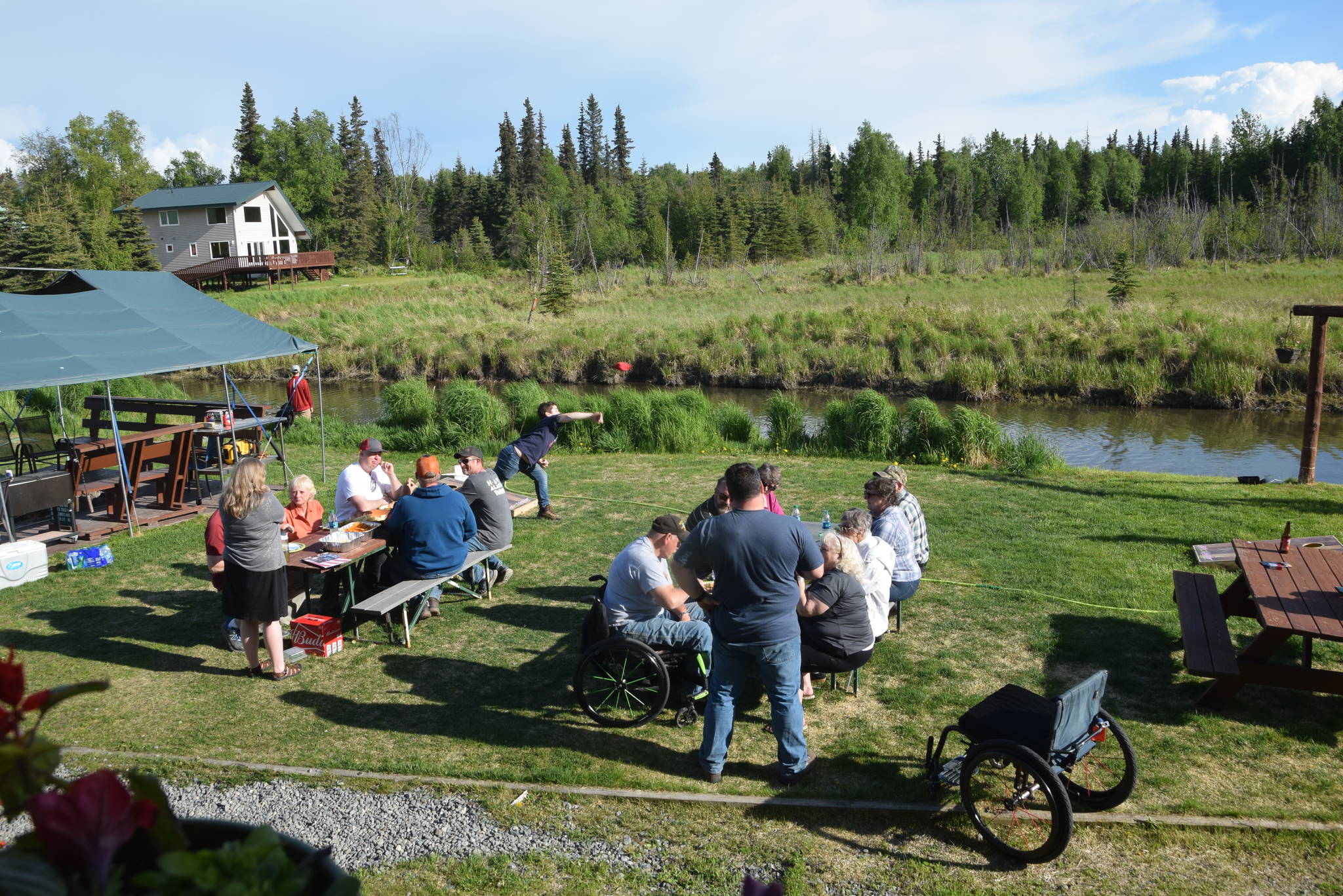 Veterans and volunteers enjoy a cookout together as part of HAVE-Alaska’s 2019 fishing trip in Soldotna, Alaska, on Wednesday, June 5, 2019. (Photo by Brian Mazurek/Peninsula Clarion)
