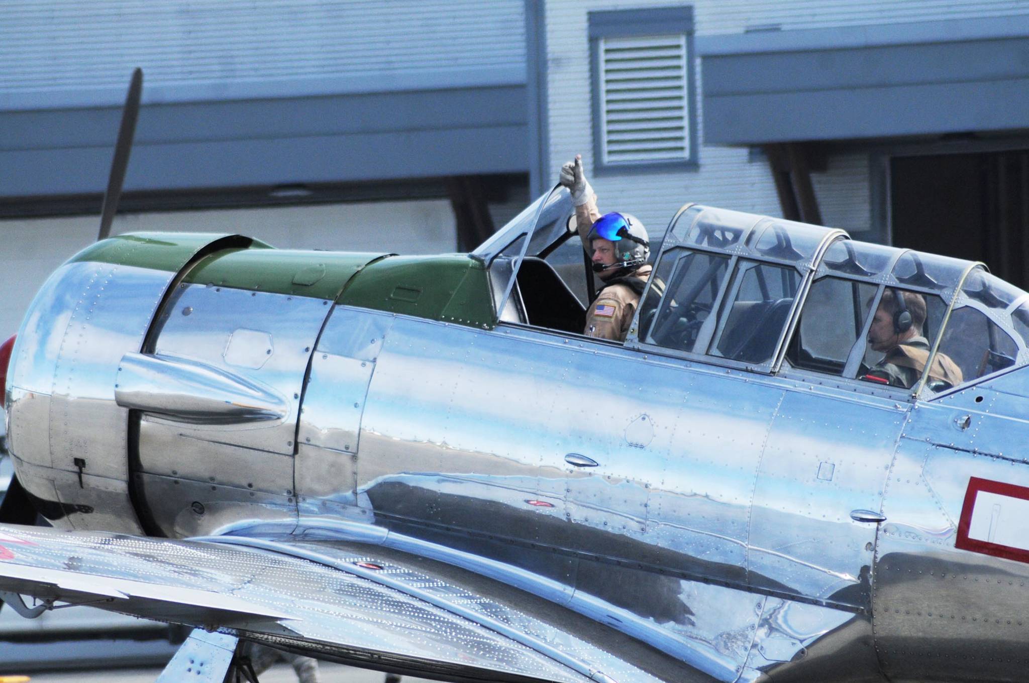 A pilot signals to the pilots on two nearby planes that he is ready to taxi at the Kenai Air Fair at the Kenai Municipal Airport on Saturday, June 9, 2018 in Kenai, Alaska. (Photo by Elizabeth Earl/Peninsula Clarion)