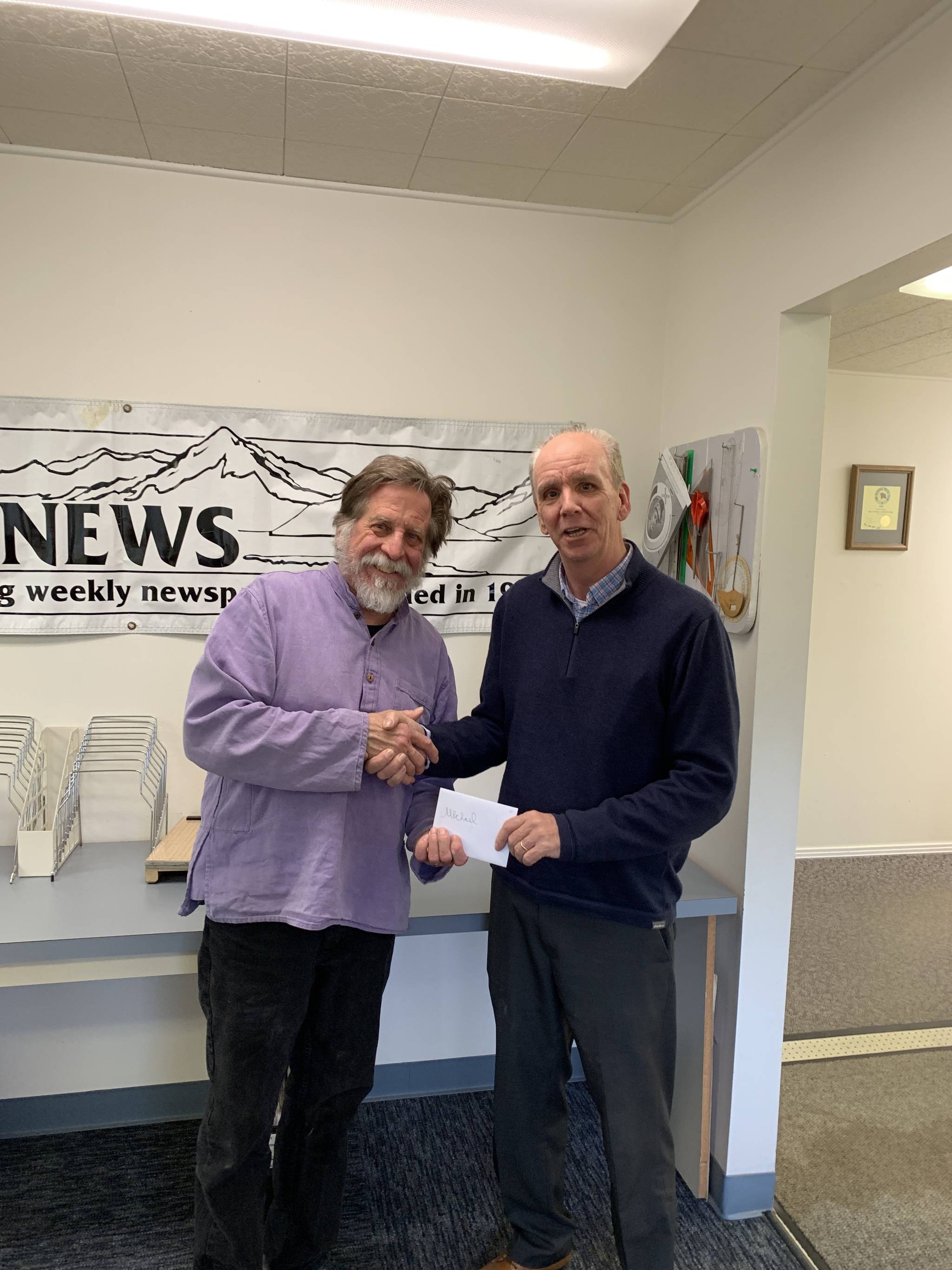 Homer News Editor Michael Armstrong, left, is presented with an award from Publisher Jeff Hayden. (Photo provided by the Homer News)