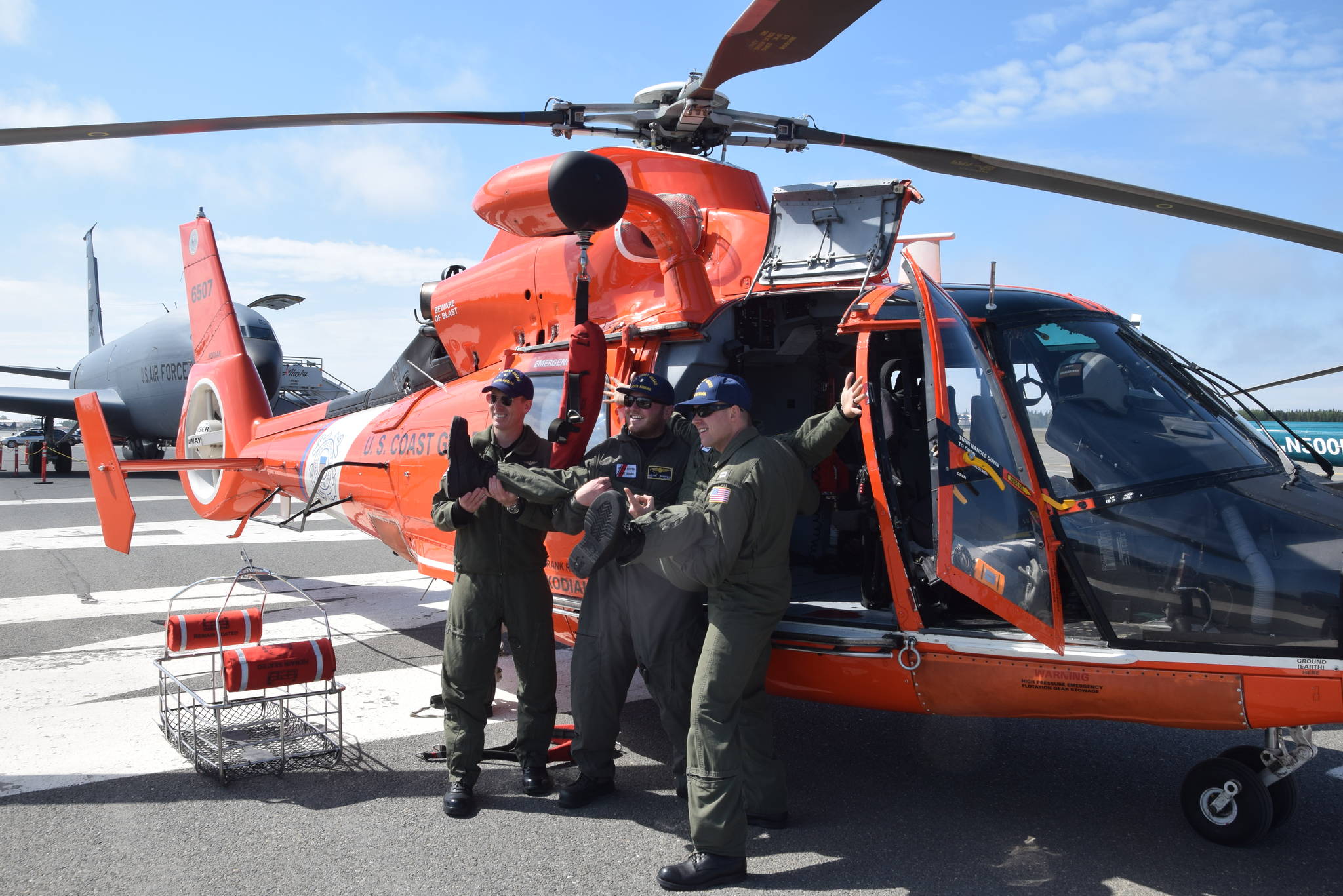 From right, Wes Jones, Jake Pritchett, Austin Robinson and Jay Kircher pose for a photo in front of a Eurocopter MH-65 Dolphin at the 19th annual Kenai Peninsula Air Fair in Kenai, Alaska on June 8, 2019. The four are part of a U.S. Coast Guard Search and Rescue Team based out of Kodiak, Alaska. (Photo by Brian Mazurek/Peninsula Clarion)