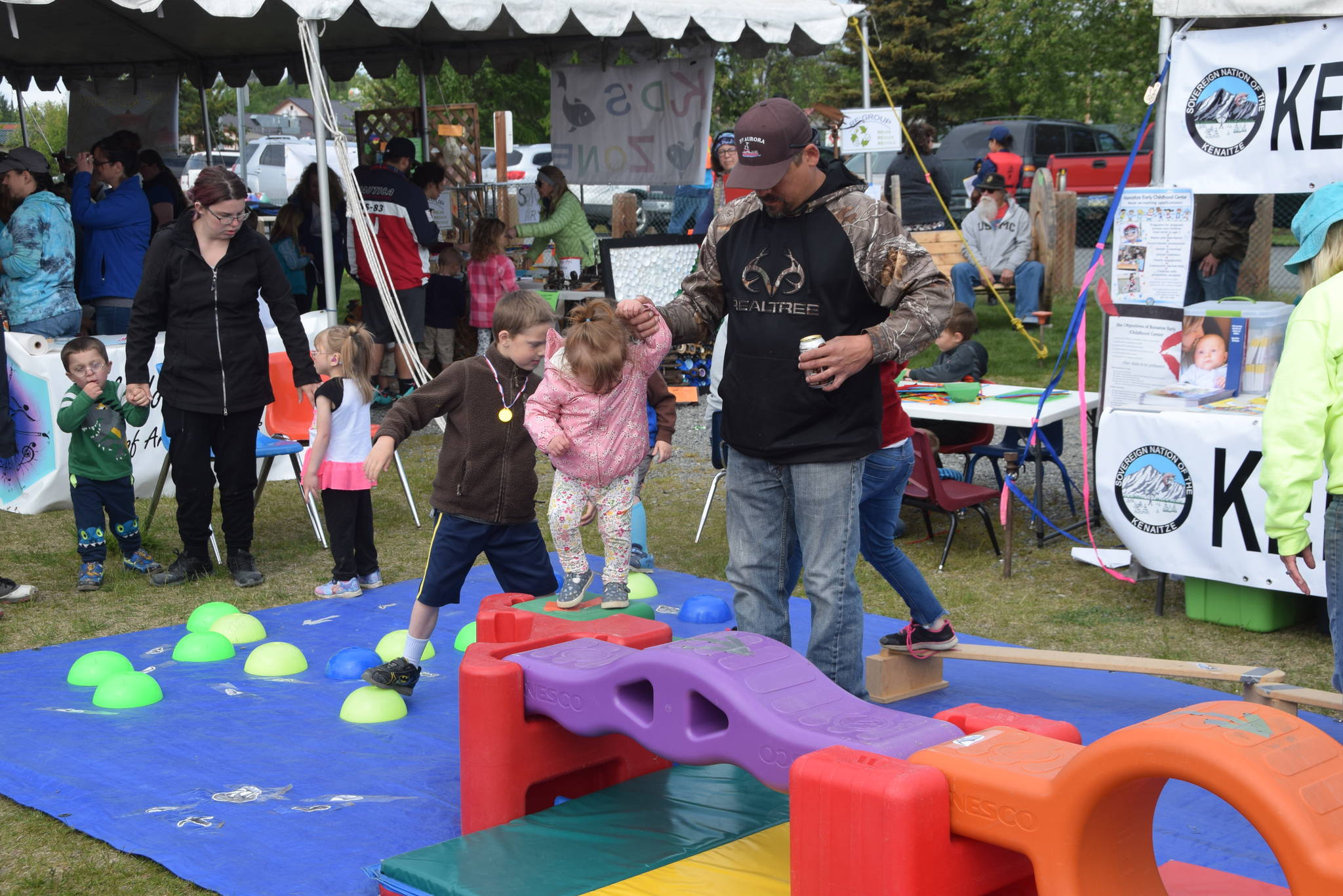 Kids and parents navigate a salmon obstacle course set up by the Kenaitze Early Childhood Center during the Kenai River Festival at Soldotna Creek Park in Soldotna, Alaska on June 8, 2019. (Photo by Brian Mazurek/Peninsula Clarion)