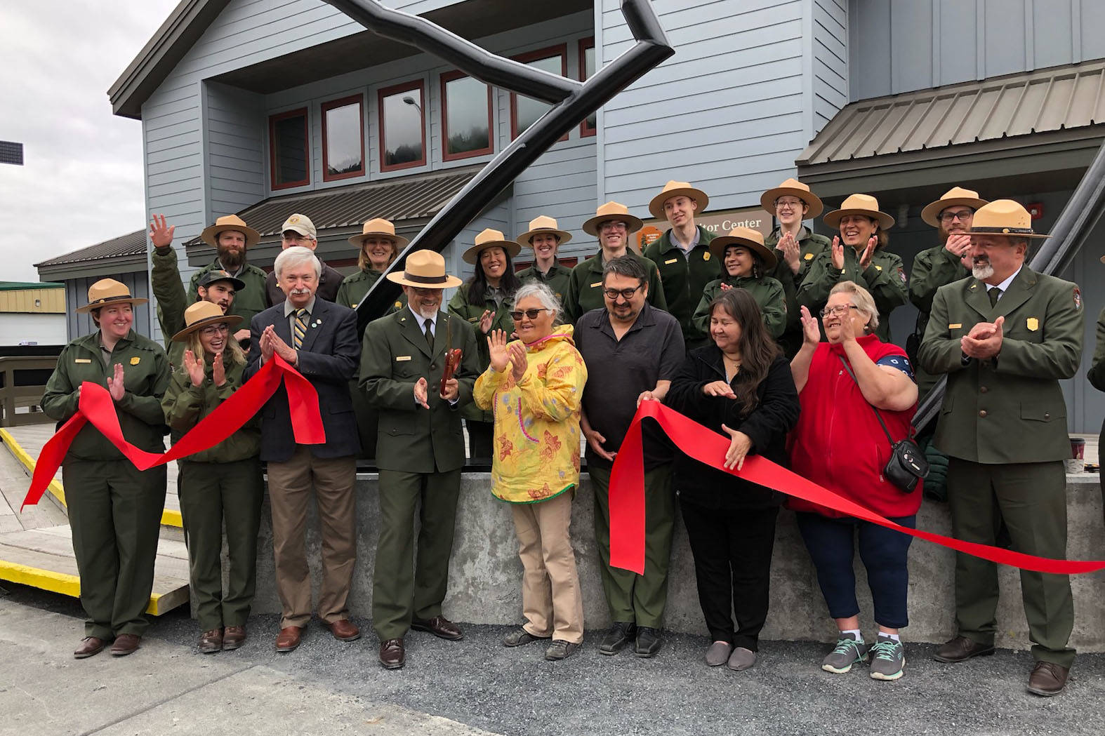 Kenai Fjords National Park employees and representatives from the Nanwalek tribe cut the ribbon at the newly renovated visitors center on Fourth Avenue. (Photo submitted by NPS Shauna Potocky)