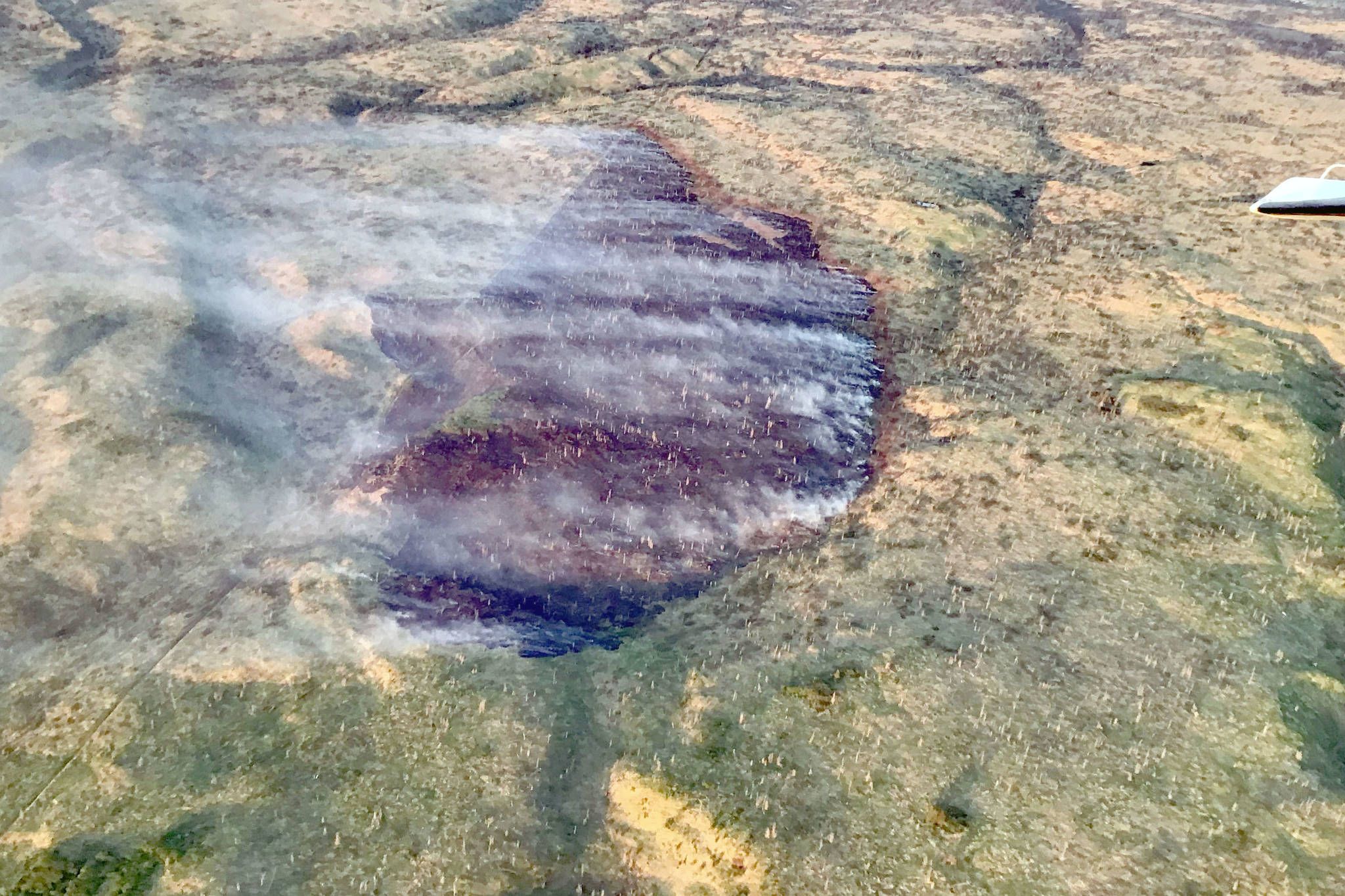 A photo of the Tustumena Lake Fire taken at 11 p.m. on Wednesday, June 5, 2019, illustrates the effect retardant and water drops had on the fire. (Photo by Jason Jordet/Alaska Division of Forestry)
