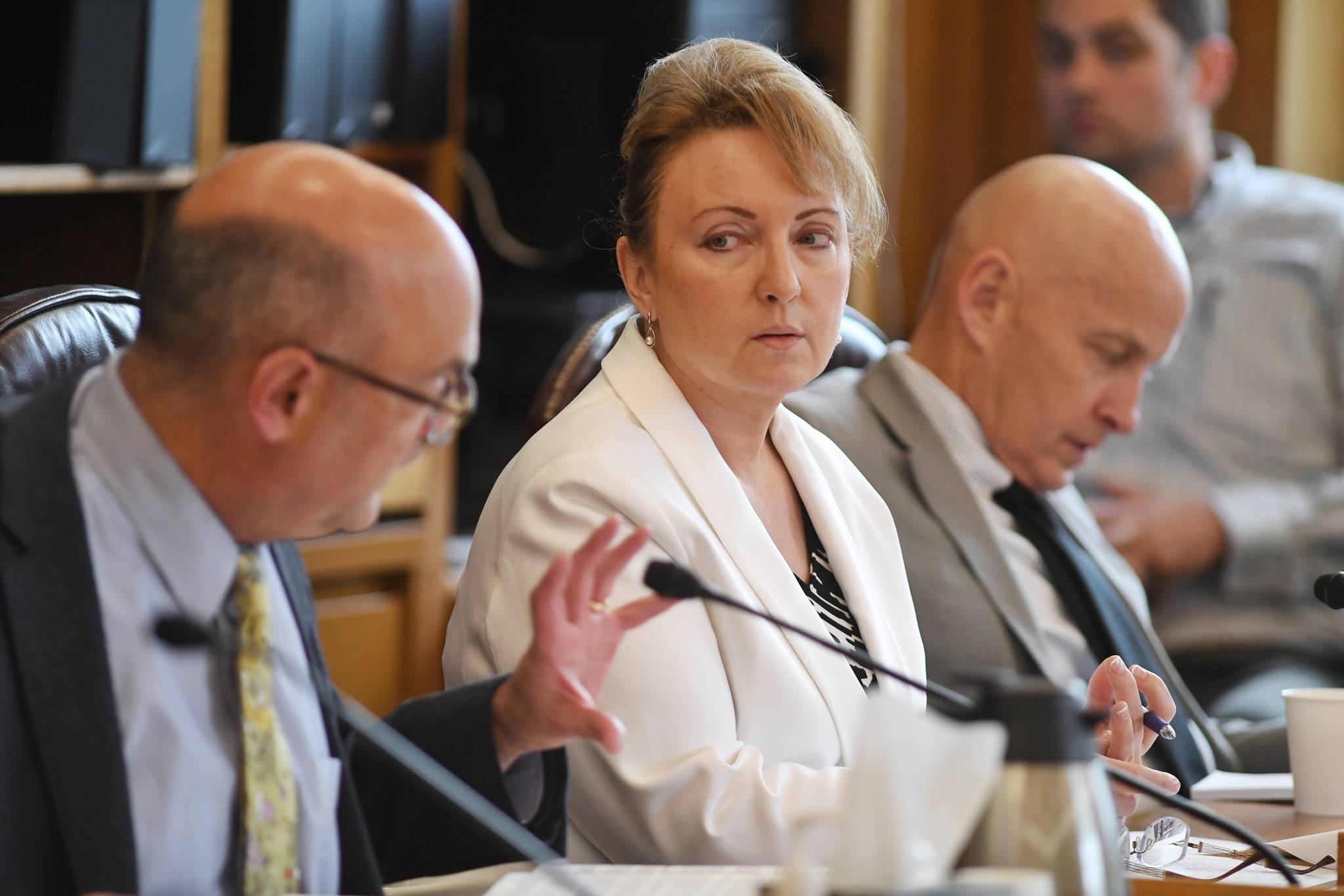 Rep. Colleen Sullivan-Leonard, R-Wasilla, center, and Rep Dan Ortiz, I-Ketchikan, right, listen to Rep. Andy Josephson, D-Anchorage, ask a question to the update to the capital budget bill during a House Finance Committee meeting at the Capitol on Tuesday, June 11, 2019. The bill passed out of committee. (Michael Penn | Juneau Empire)