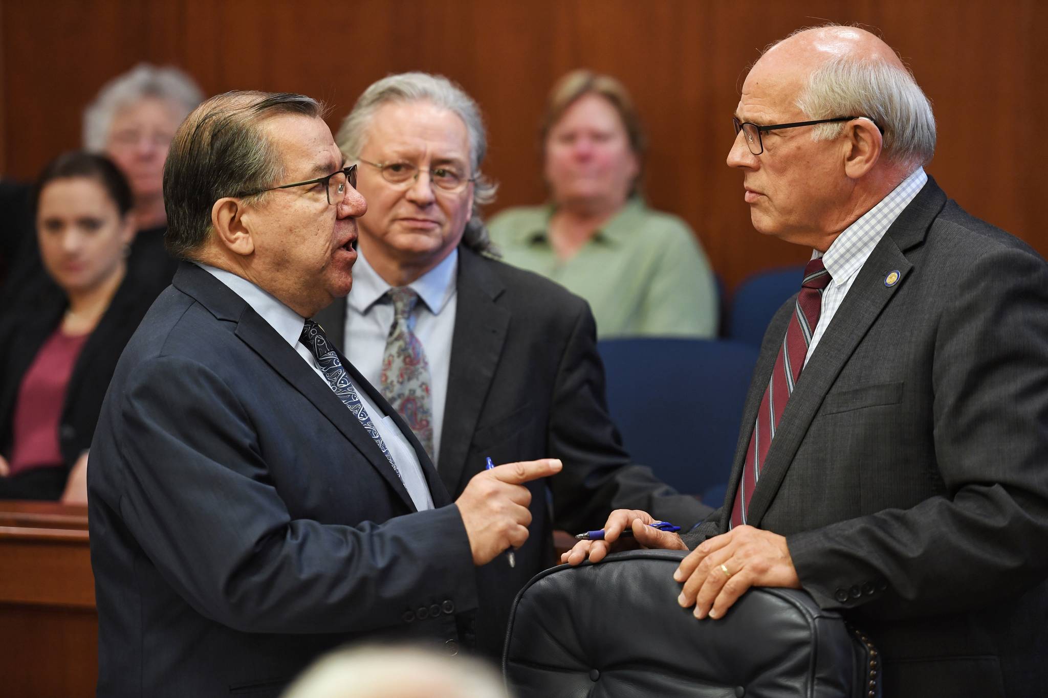 Sen. Lyman Hoffman, D-Bethel, left, expresses his displeasure with Sen. John Coghill, R-North Pole, right, as Sen. Tom Begich listens, during debate on the capital budget in the Senate at the Capitol on Thursday, June 13, 2019. (Michael Penn | Juneau Empire)