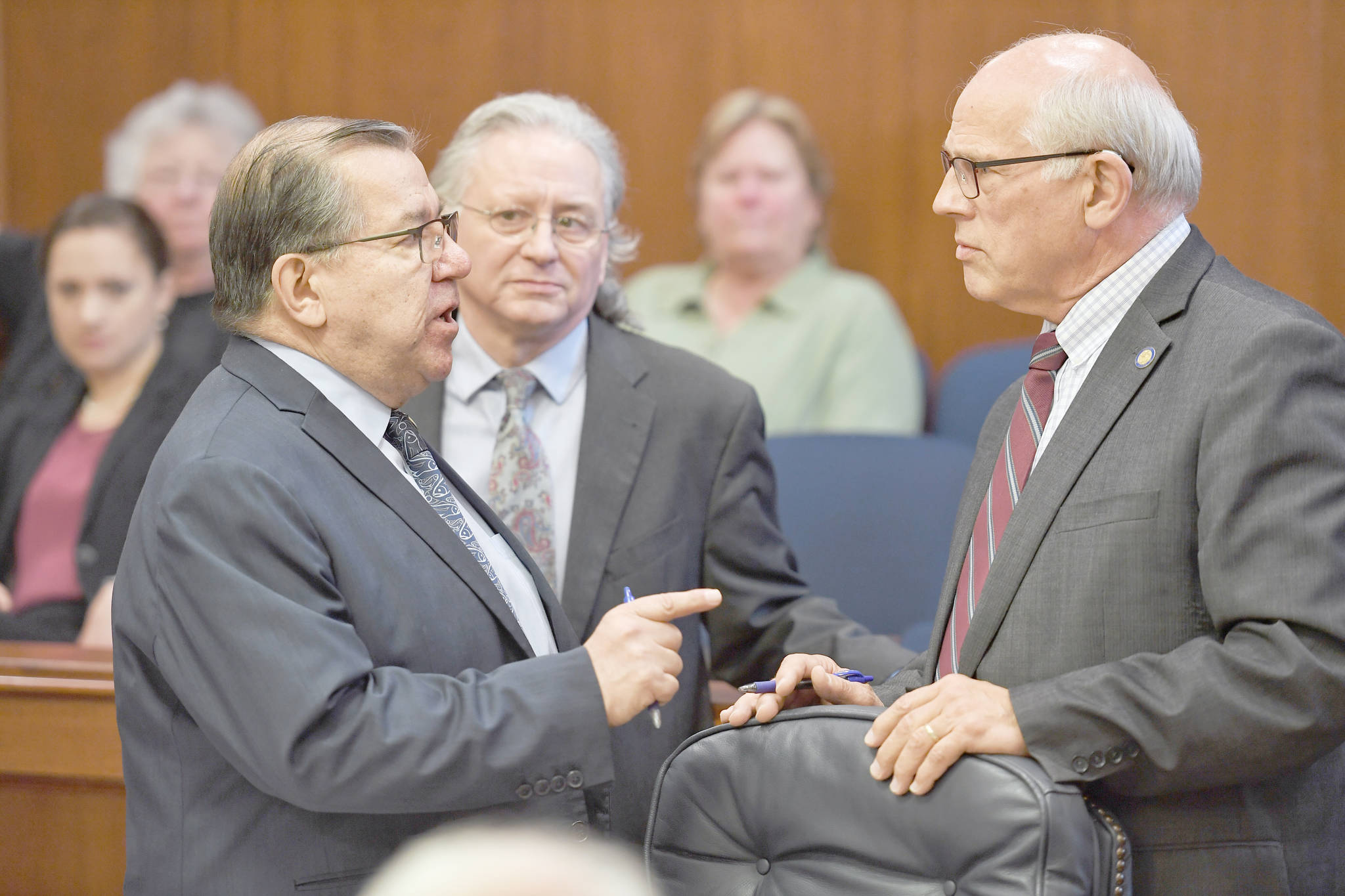 Sen. Lyman Hoffman, D-Bethel, left, expresses his displeasure with Sen. John Coghill, R-North Pole, right, as Sen. Tom Begich listens, during debate on the capital budget in the Senate at the Capitol on Thursday. (Michael Penn/Juneau Empire)
