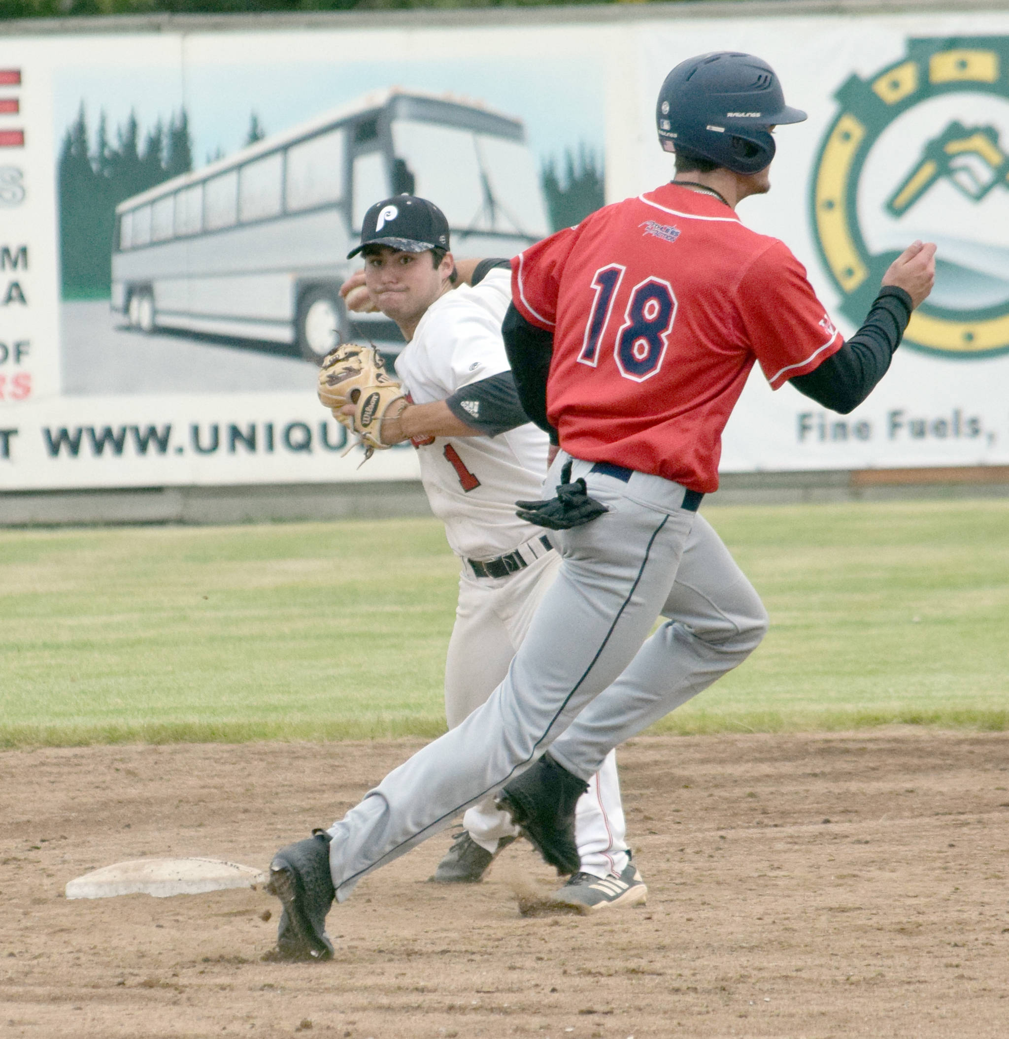 Oilers second baseman Ethan Patrick turns a double play in front of Brandon Cody of the Chugiak-Eagle River Chinooks on Friday, June 15, 2019, at Coral Seymour Memorial Park in Kenai, Alaska. (Photo by Jeff Helminiak/Peninsula Clarion)