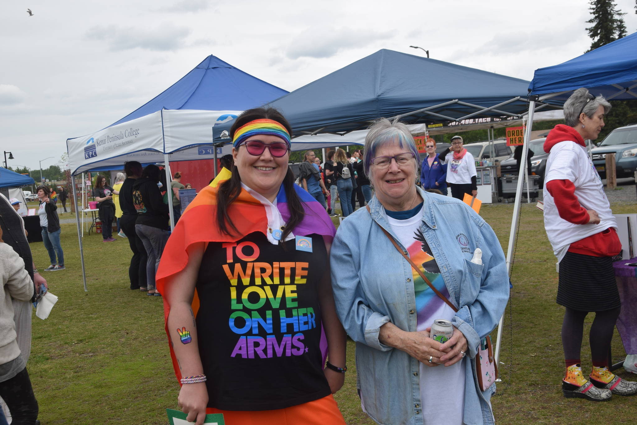 Karina Lorenzo, left, and Marti Slater, right, smile for the camera during the 2019 Soldotna Pride Celebration in Soldotna Creek Park on Saturday, June 15, 2019. (Photo by Brian Mazurek/Peninsula Clarion)