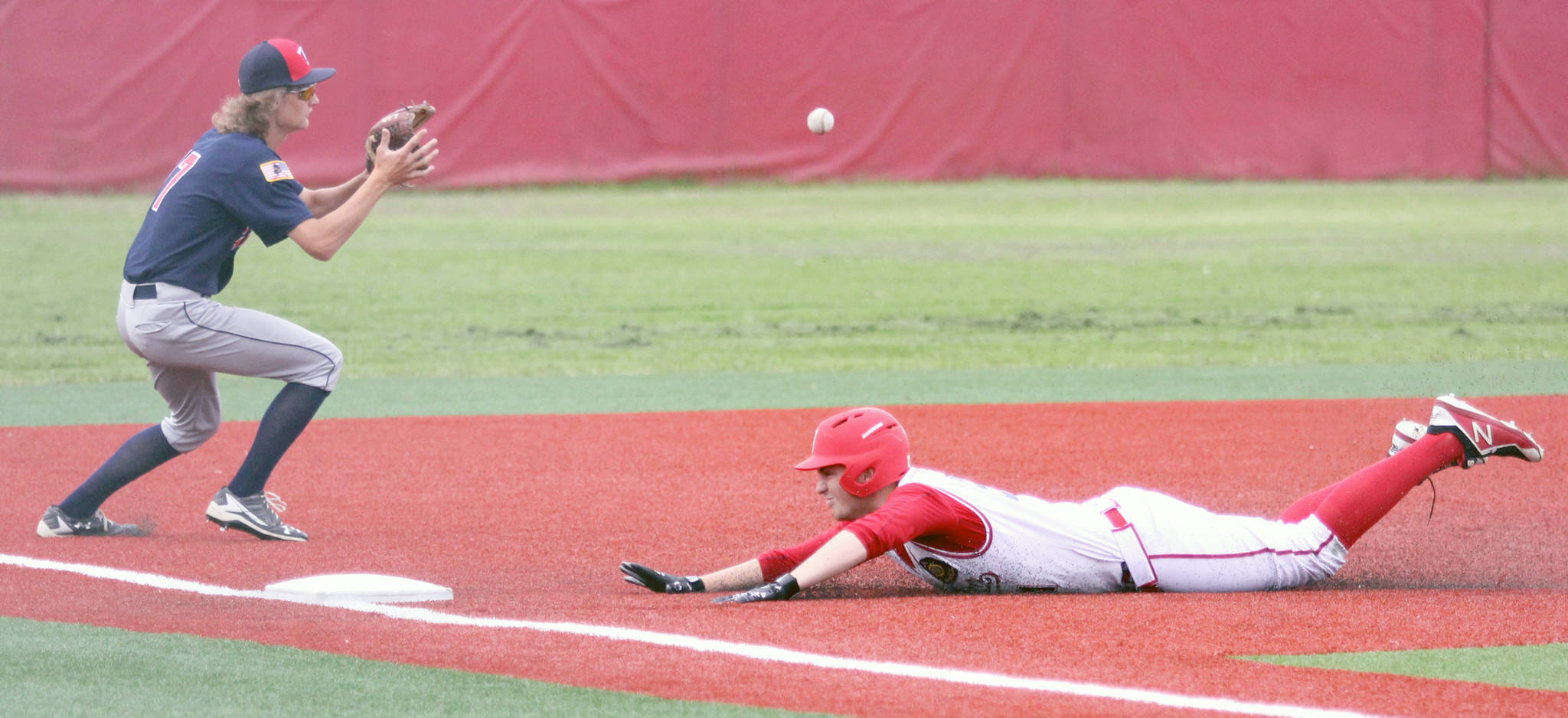 Kenai infielder Davey Belger catches a throw from right field as Wasilla’s Kyle Graham slides into third during a doubleheader at Wasilla High School on Saturday, June 15, 2019. (Photo by Jeremiah Bartz/Frontiersman)