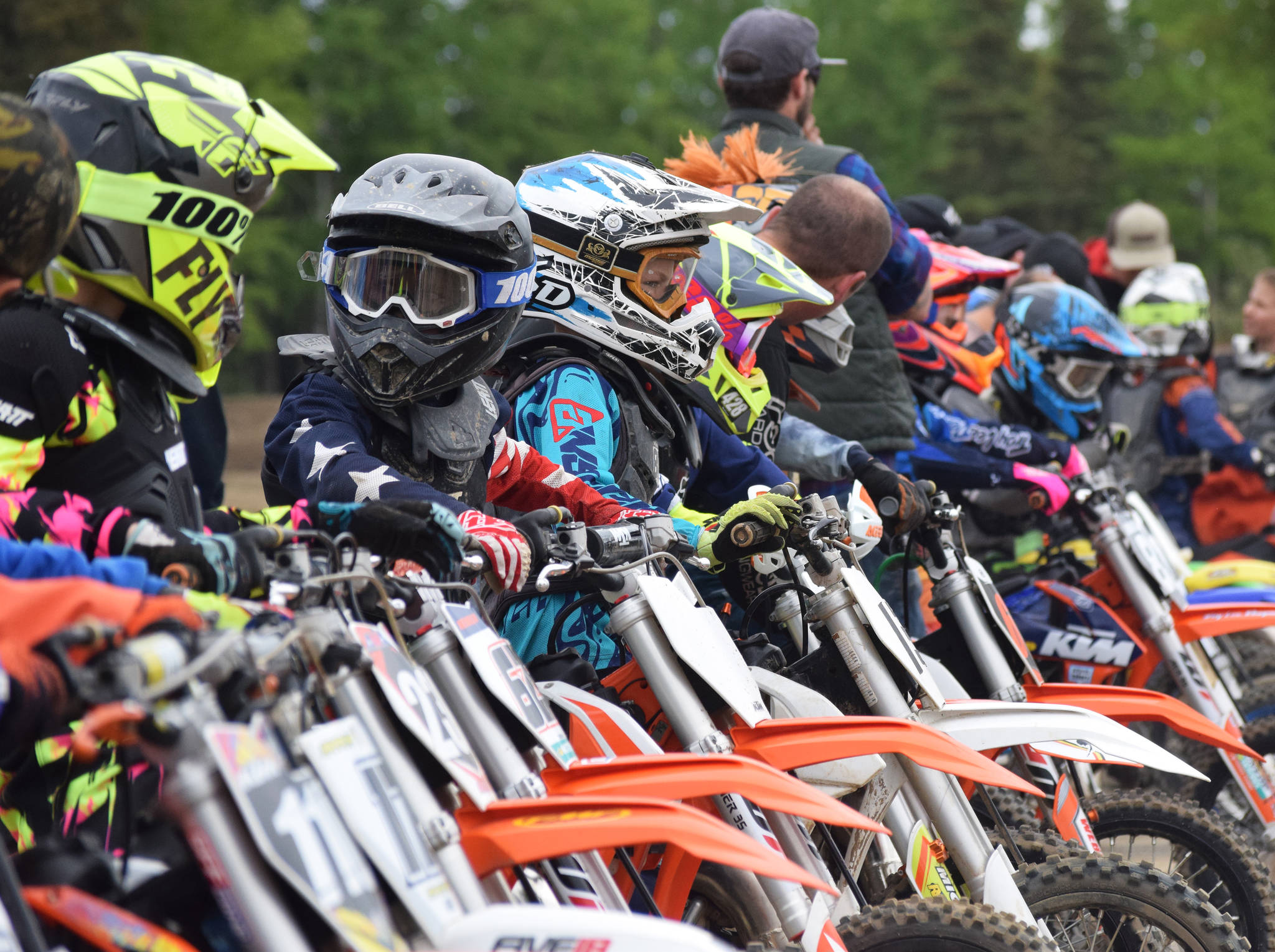 Young riders in the 65cc class prepare to take off for the start Saturday, June 15, 2019, at the Alaska State Motocross Championships at Twin City Raceway’s motocross track in Kenai, Alaska. (Photo by Joey Klecka/Peninsula Clarion)