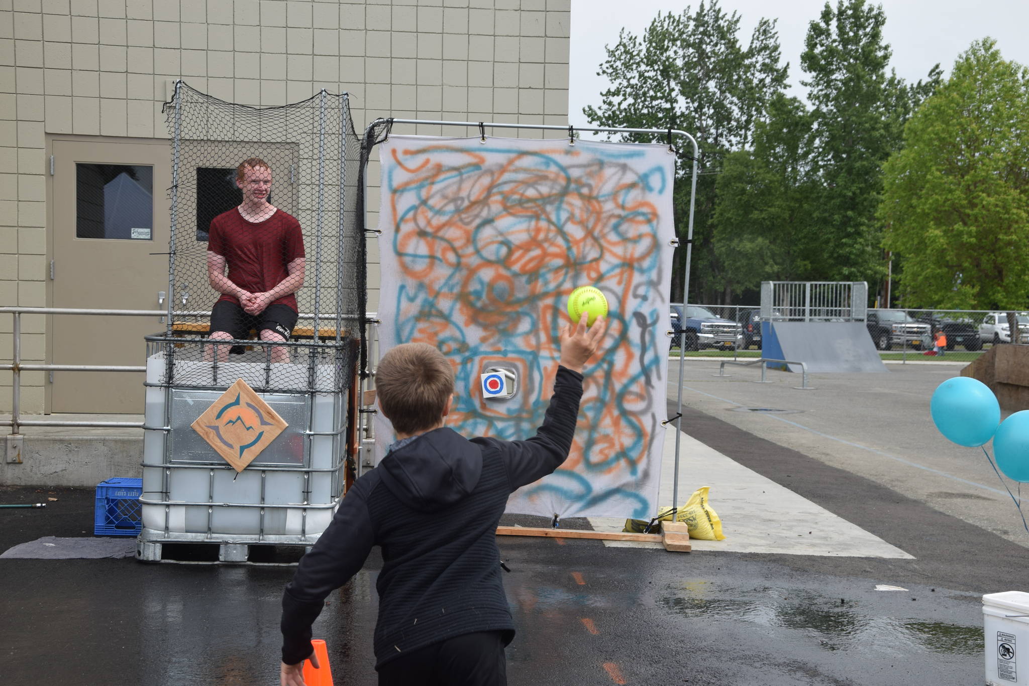 A boy tries his hand at the Compass Dunk Tank during the Family Fun in the Midnight Sun festival at the North Peninsula Recreation Center in Nikiski, Alaska on June 15, 2019. (Photo by Brian Mazurek/Peninsula Clarion)