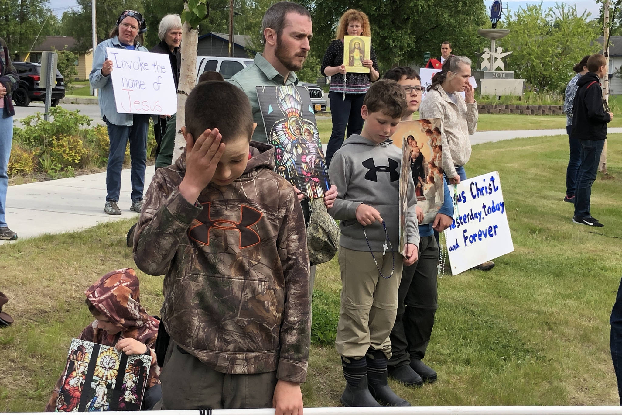 Demonstrators hold signs outside the Kenai Peninsula Borough building in protest of an invocation by a member of the Satanic Temple on Tuesday, June 18, 2019 in Soldotna, Alaska. The invocation was the first given by the Satanic Temple since the borough changed its invocation policy following an Alaska Superior Court decision finding the policy unconstitutional and in violation of the state’s constitution’s establishment clause. (Photo courtesy Aud Walaszek)