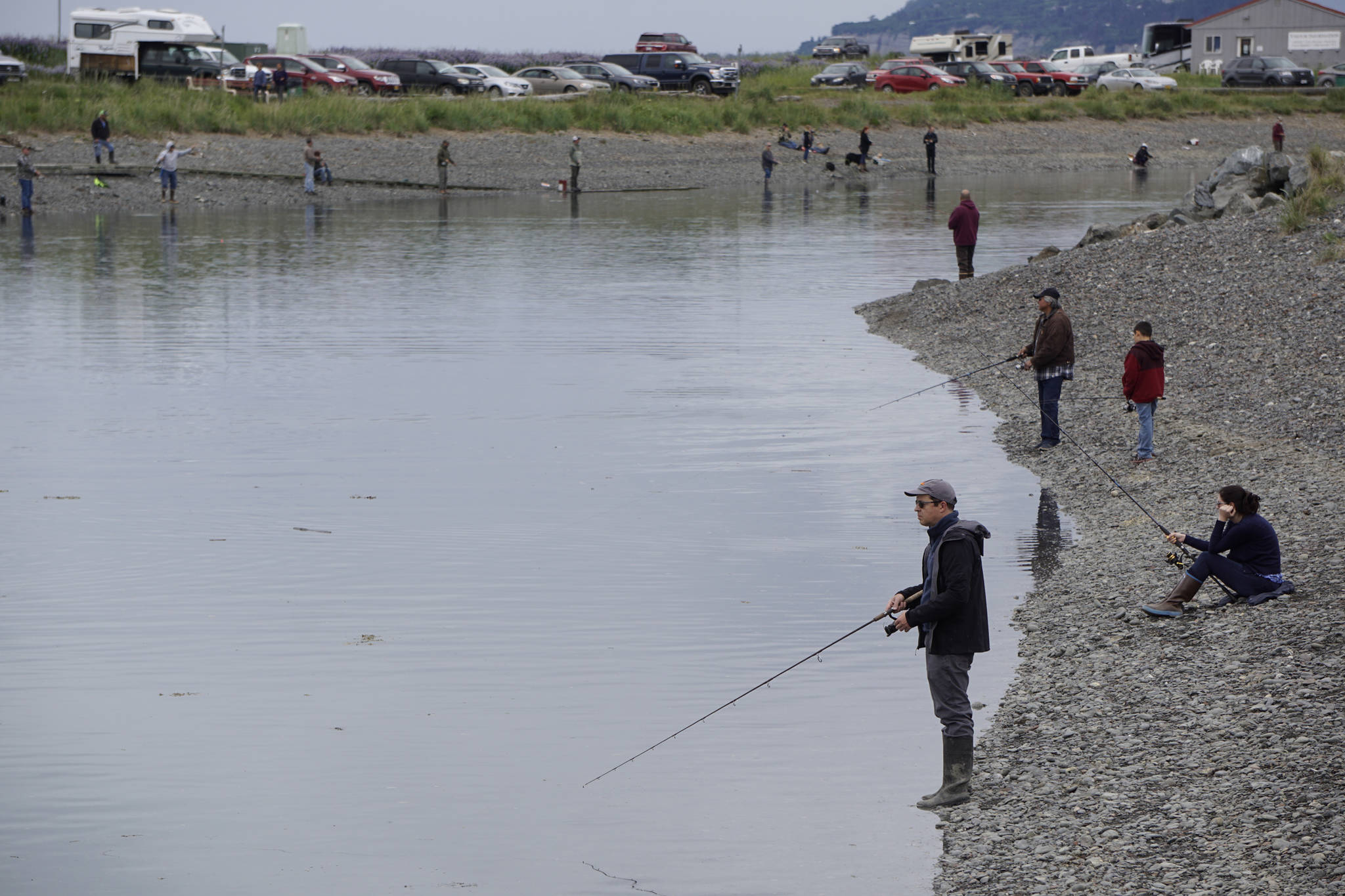 Anglers fish at the Nick Dudiak Fishing Lagoon on Saturday, June 15, 2019, at the Homer Spit in Homer, Alaska. (Photo by Michael Armstrong/Homer News)