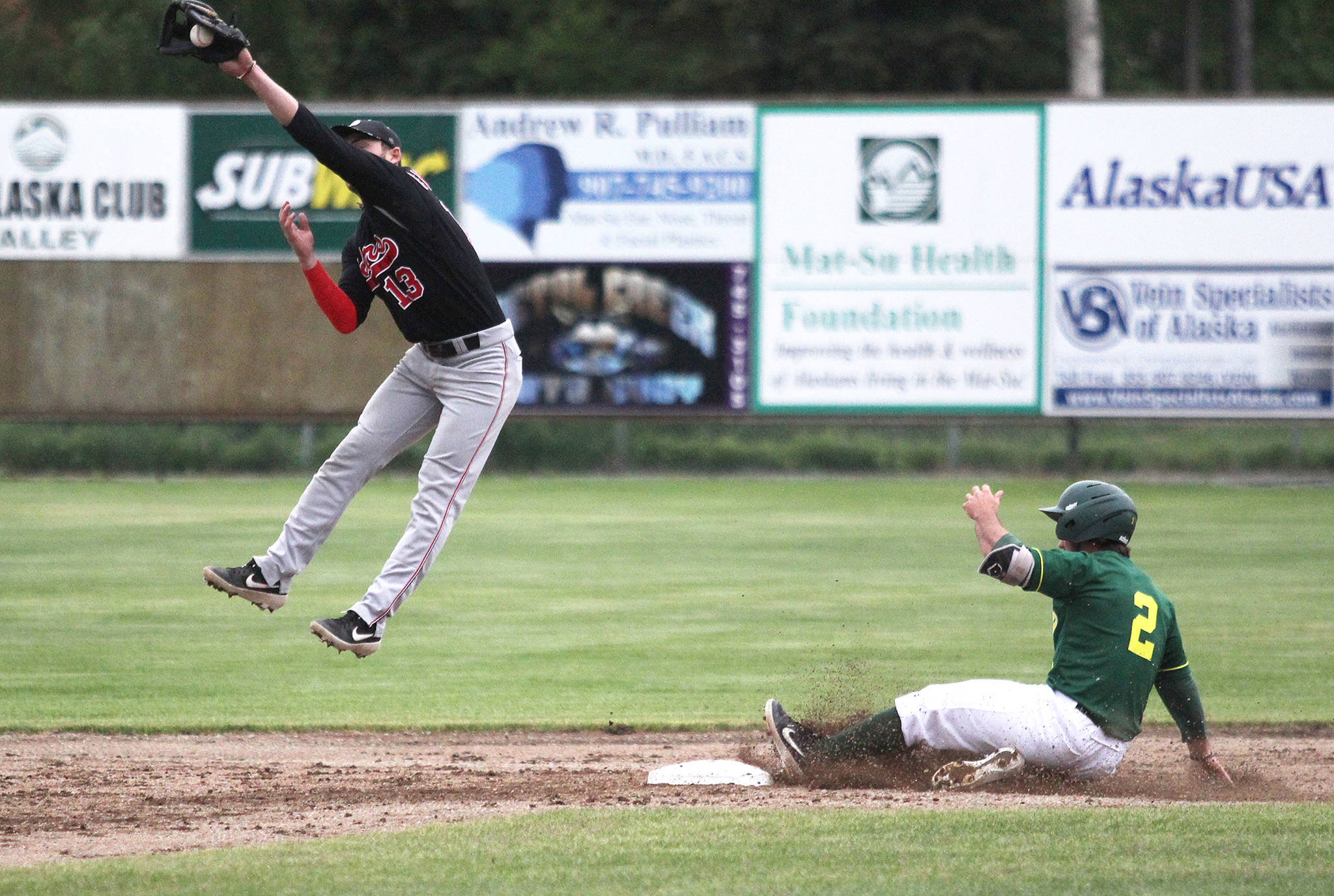 Peninsula Oilers infielder Victor Carlino leaps up into the air to grab the throw to second as Mat-Su’s Erik Webb slides in safely during an 8-4 loss to the Miners Tuesday, June 18, 2019 in Palmer. (Photo by Jeremiah Bartz/Mat-Su Valley Frontiersman)