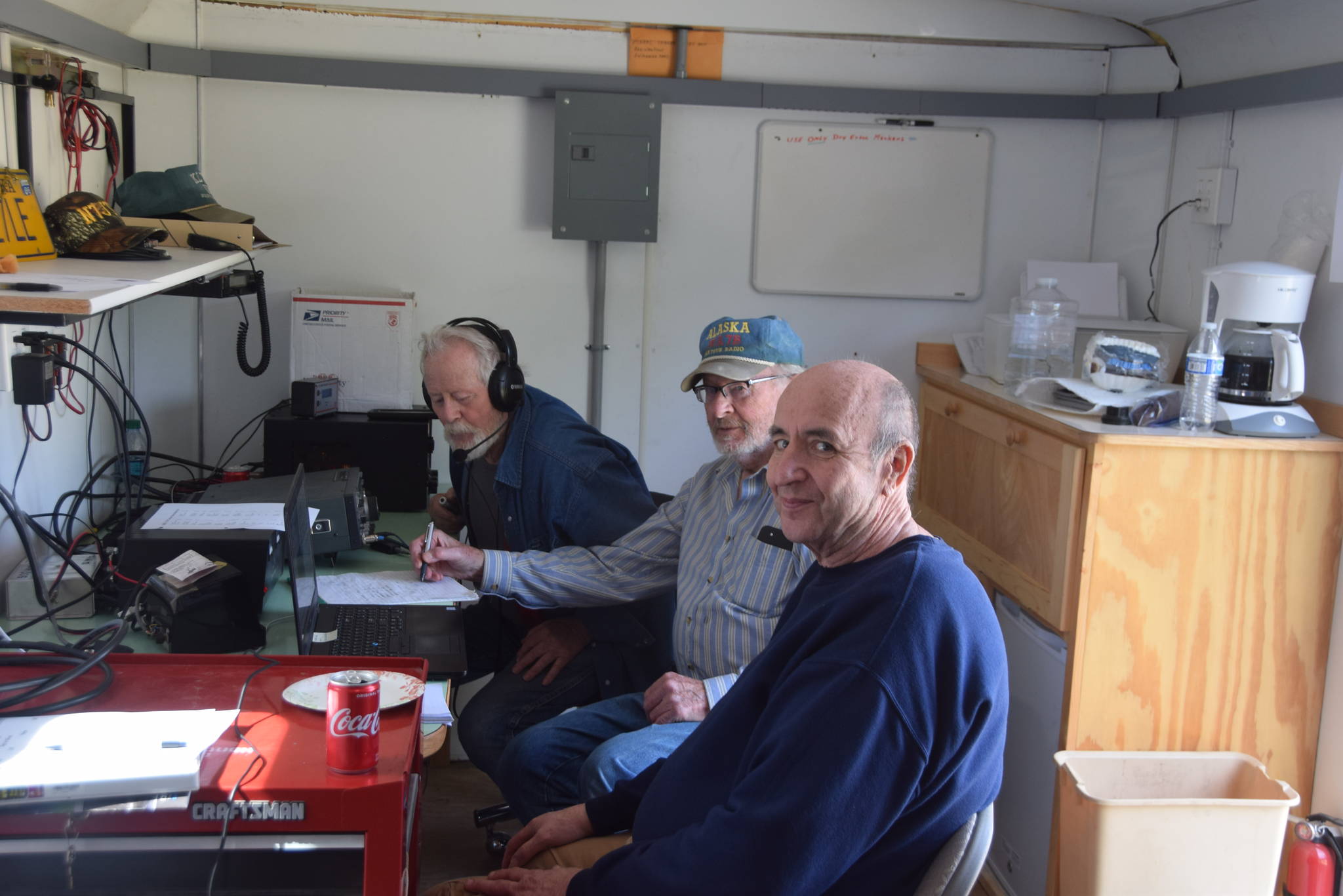 From left, George Van Lone, Max Carpenter and Ed Seaward monitor the airwaves inside the Moose Horn Amateur Radio Club’s mobile operation center in Kenai, Alaska during the Amateur Radio Relay League’s annual Field Day on June 22, 2019. (Photo by Brian Mazurek/Peninsula Clarion)