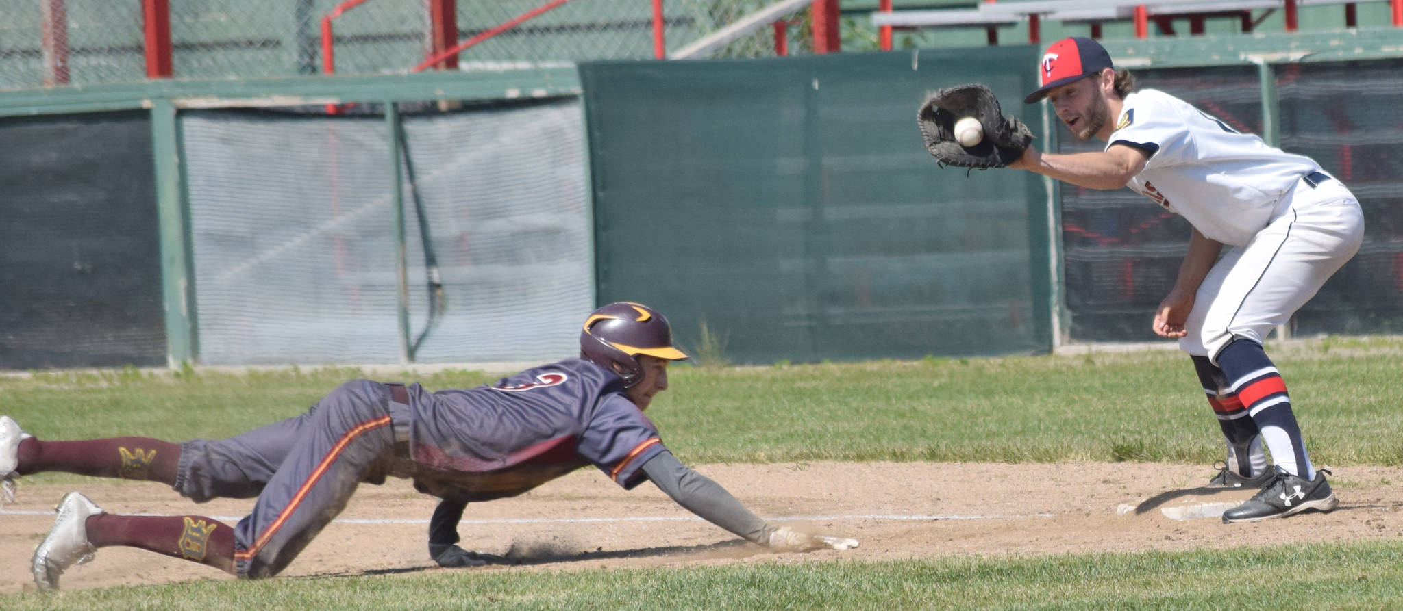 Alex Bruce of Dimond is picked off first base, with Post 20 Twins’ Seth Adkins providing the tag, on Sunday, June 23, 2019, at Coral Seymour Memorial Park in Kenai, Alaska. (Photo by Jeff Helminiak/Peninsula Clarion)
