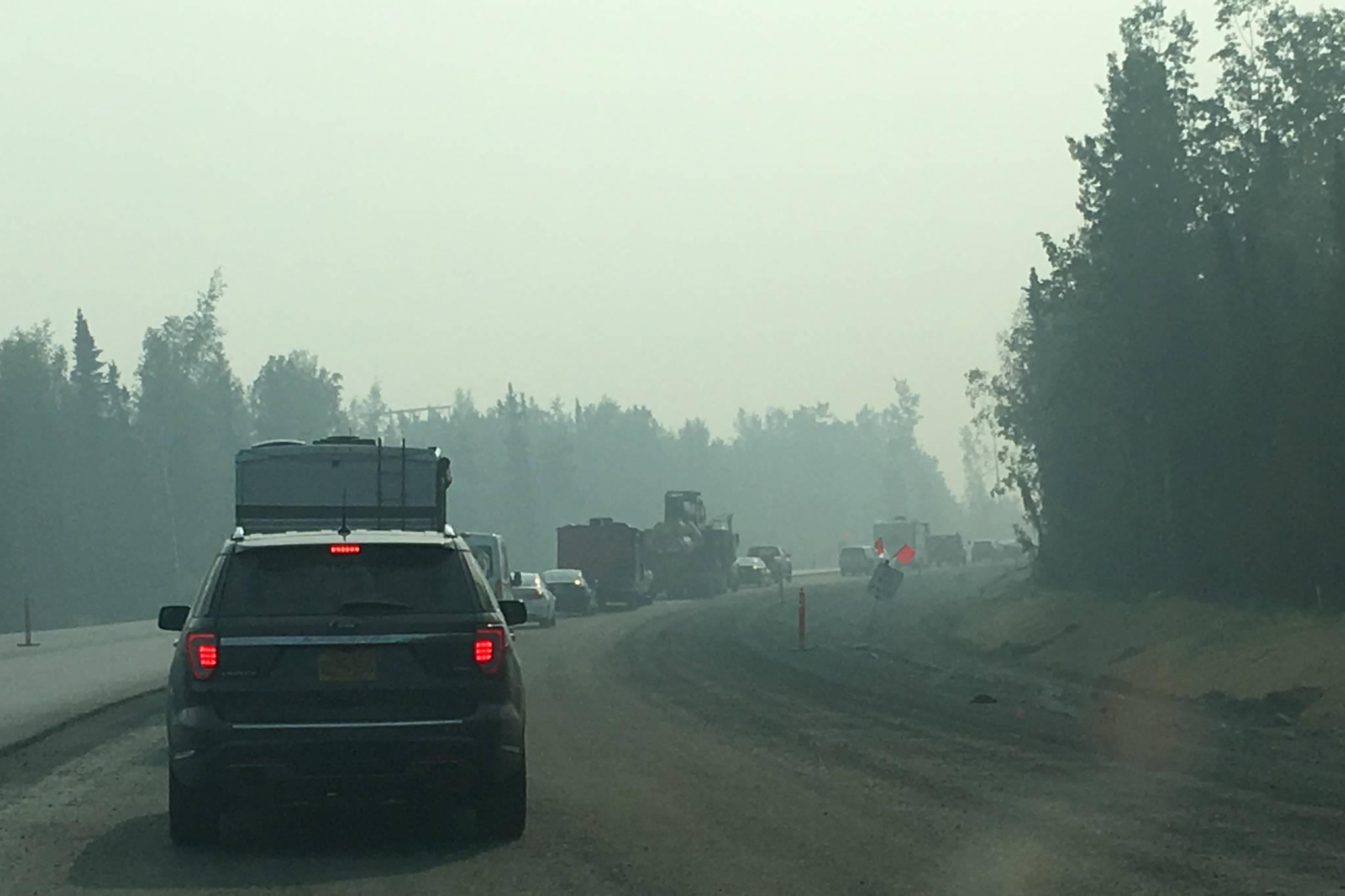 Cars are backed up along the Sterling Highway on Alaska’s Kenai Peninsula on Wednesday, June 26, 2019. The highway was closed for several hours Wednesday morning due to the Swan Lake Fire north of the highway. (Photo by Jeff Helminiak/Peninsula Clarion)