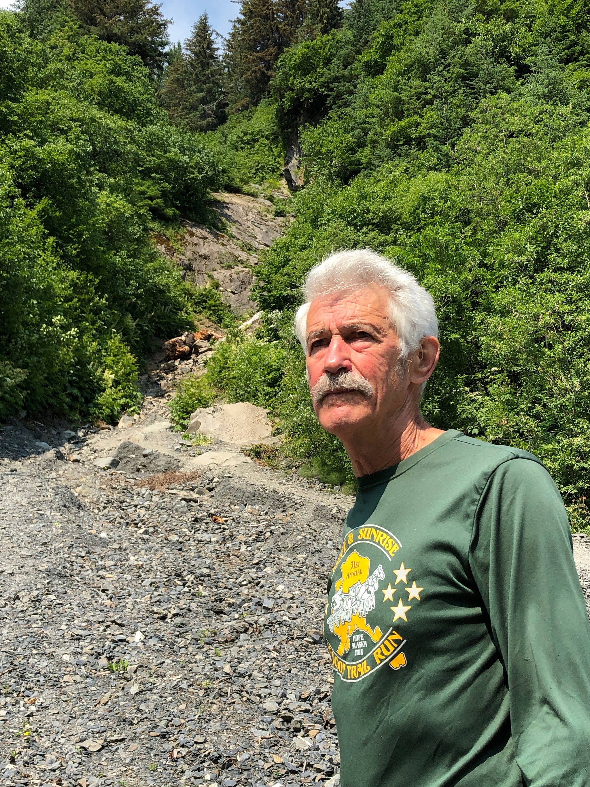 Seward’s Fred Moore stands at the base of Mount Marathon in Seward, Alaska, on Monday, June 24. Moore will run in his 50th consecutive Mount Marathon race on July 4. (Photo by Joey Klecka/Peninsula Clarion)