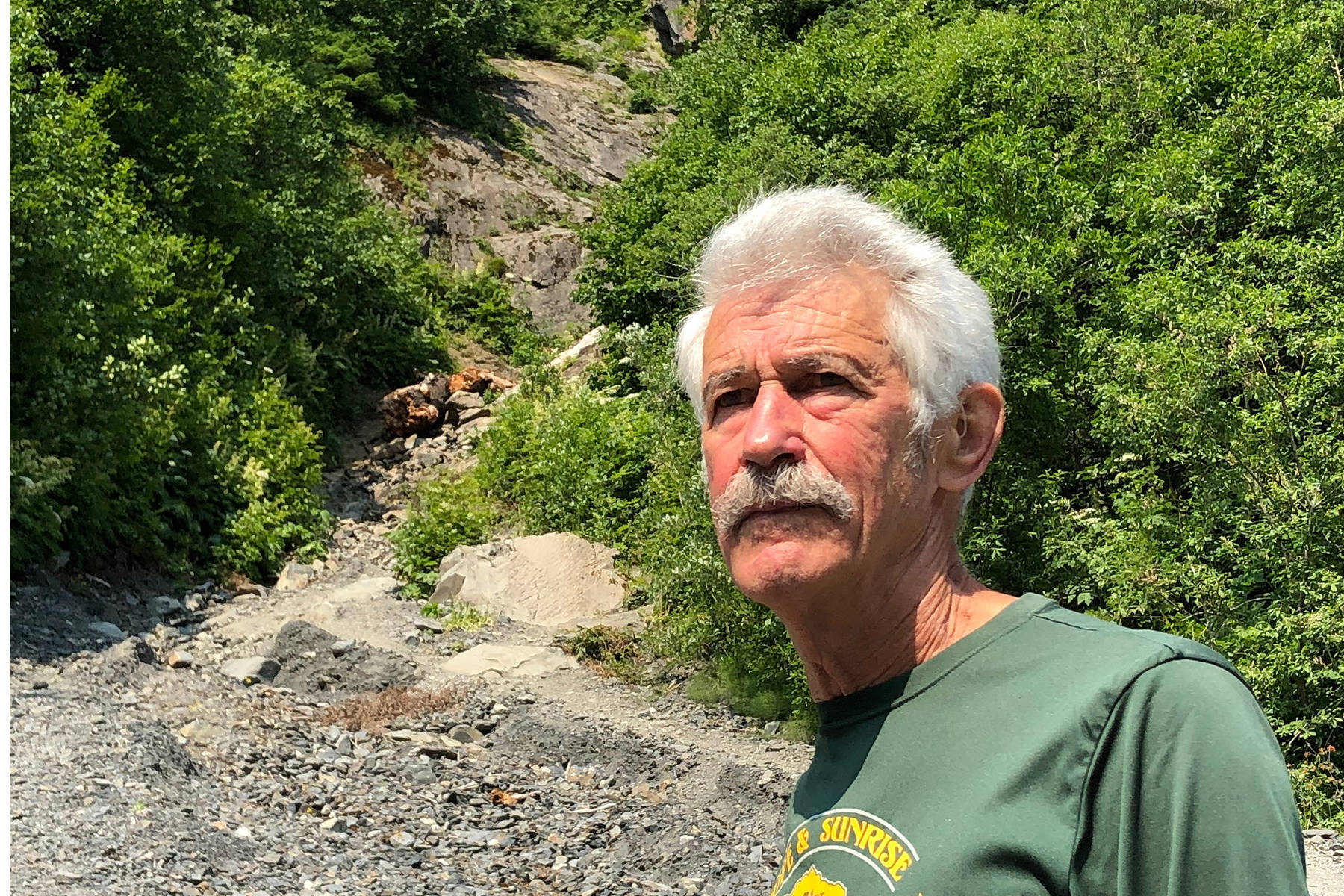 Seward’s Fred Moore stands at the base of Mount Marathon in Seward, Alaska, on Monday, June 24, 2019. Moore will run in his 50th consecutive Mount Marathon race on July 4. (Photo by Joey Klecka/Peninsula Clarion)