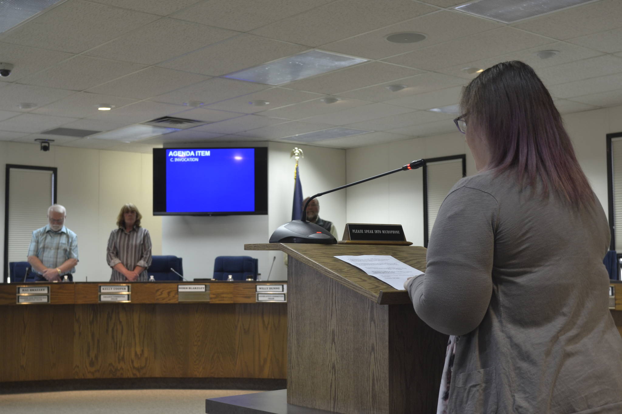 Kenai Peninsula Borough resident and member of the Satanic Temple, Iris Fontana, offers an invocation at the Kenai Peninsula Borough Assembly meeting, which prompted borough official and attendee walkouts and a protest on Tuesday, June 18, 2019, in Soldotna, Alaska. (Photo by Victoria Petersen/Peninsula Clarion)