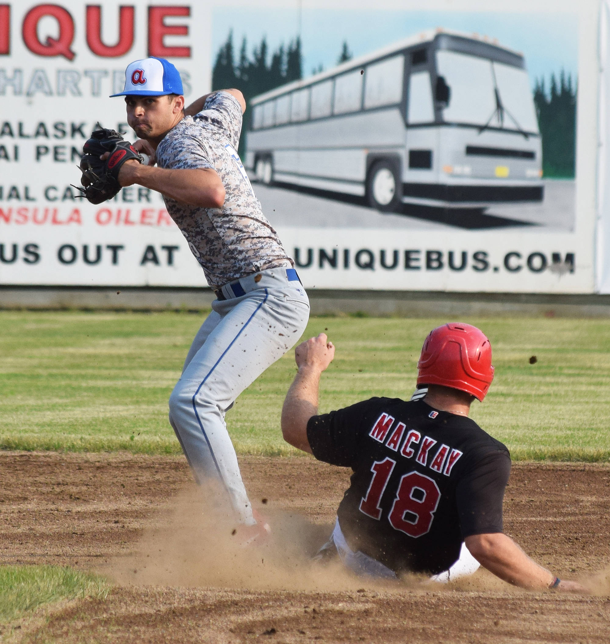 Anchorage Glacier Pilots second baseman Zach Sehgal (left) looks to turn a double play in front of Peninsula Oilers runner John Mackay, Friday, June 28, 2019, at Coral Seymour Memorial Park in Kenai. (Photo by Joey Klecka/Peninsula Clarion)