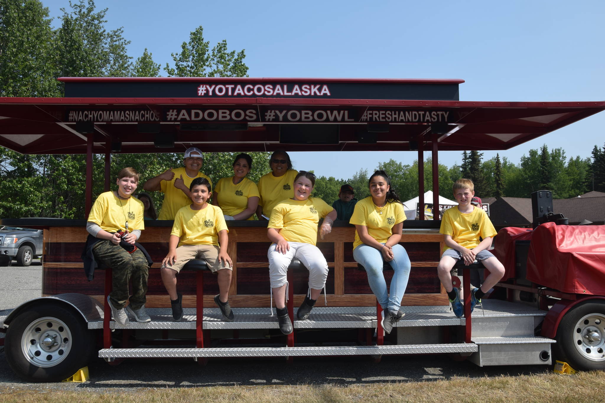 From left, front, Aries Lyons, Logan Amaya, Autumn Bass, Alexa Menzel and Tucker Challans pose with the Yo! Tacos crew during Lemonade Day in Soldotna, Alaska on June 29, 2019. (Photo by Brian Mazurek/Peninsula Clarion)