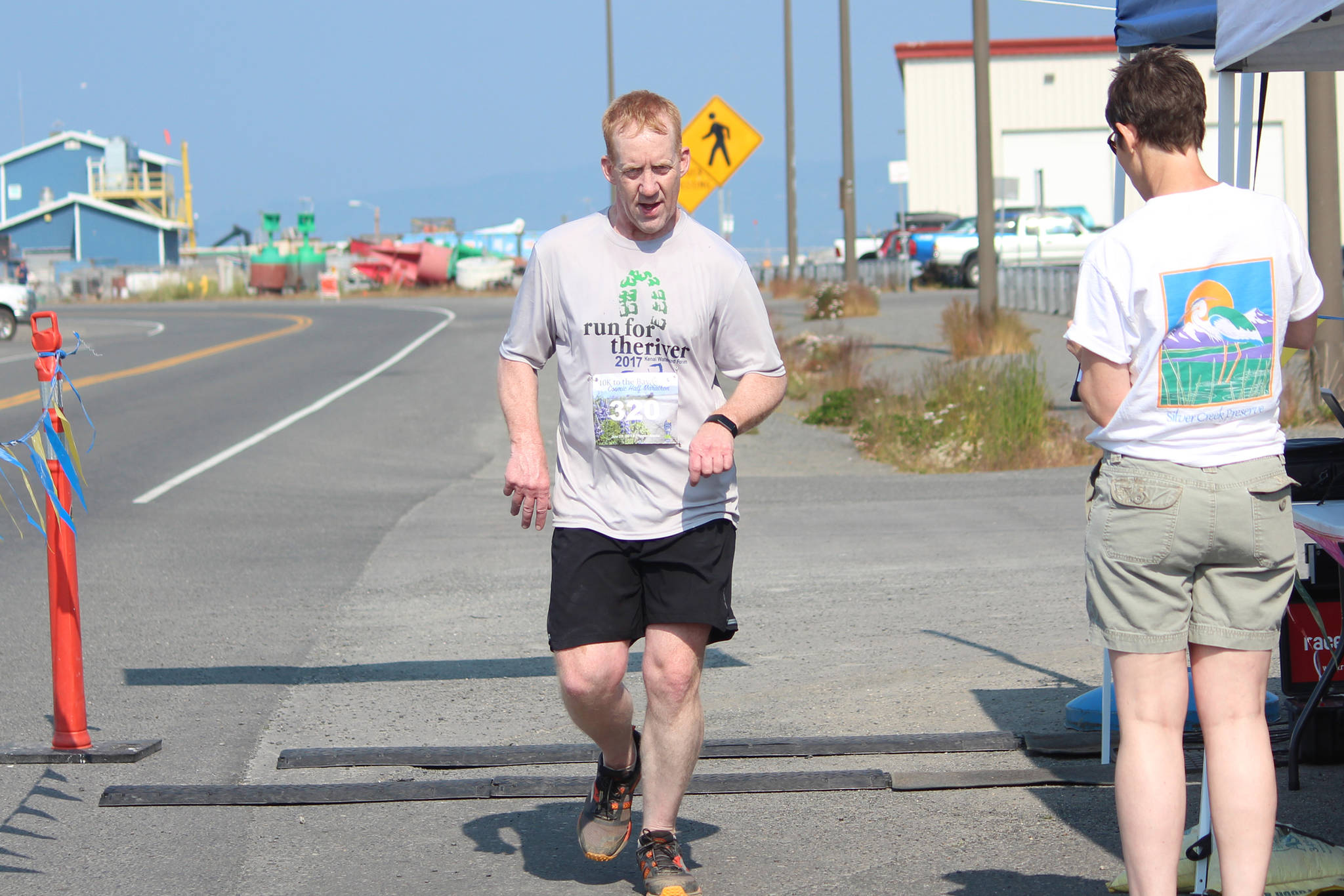 Soldotna’s Kent Peterson crosses the finish line of the Spit Run 10K to the Bay on Saturday, June 29, 2019 in Homer, Alaska. (Photo by Megan Pacer/Homer News)