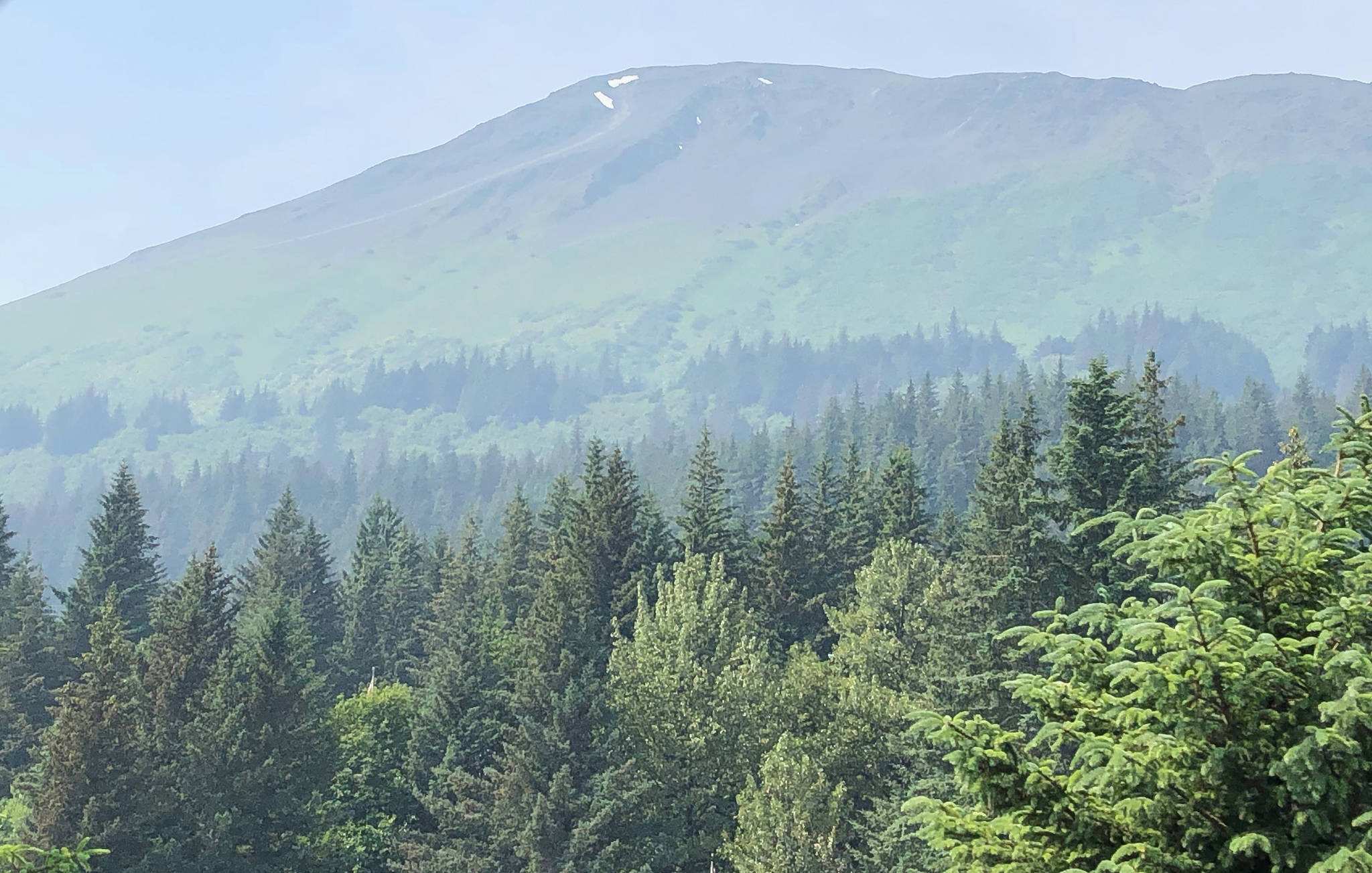 A haze of wildfire smoke hangs around the slopes of Mount Marathon in Seward, Alaska, on July 1, 2019. (Photo by Joey Klecka/Peninsula Clarion)