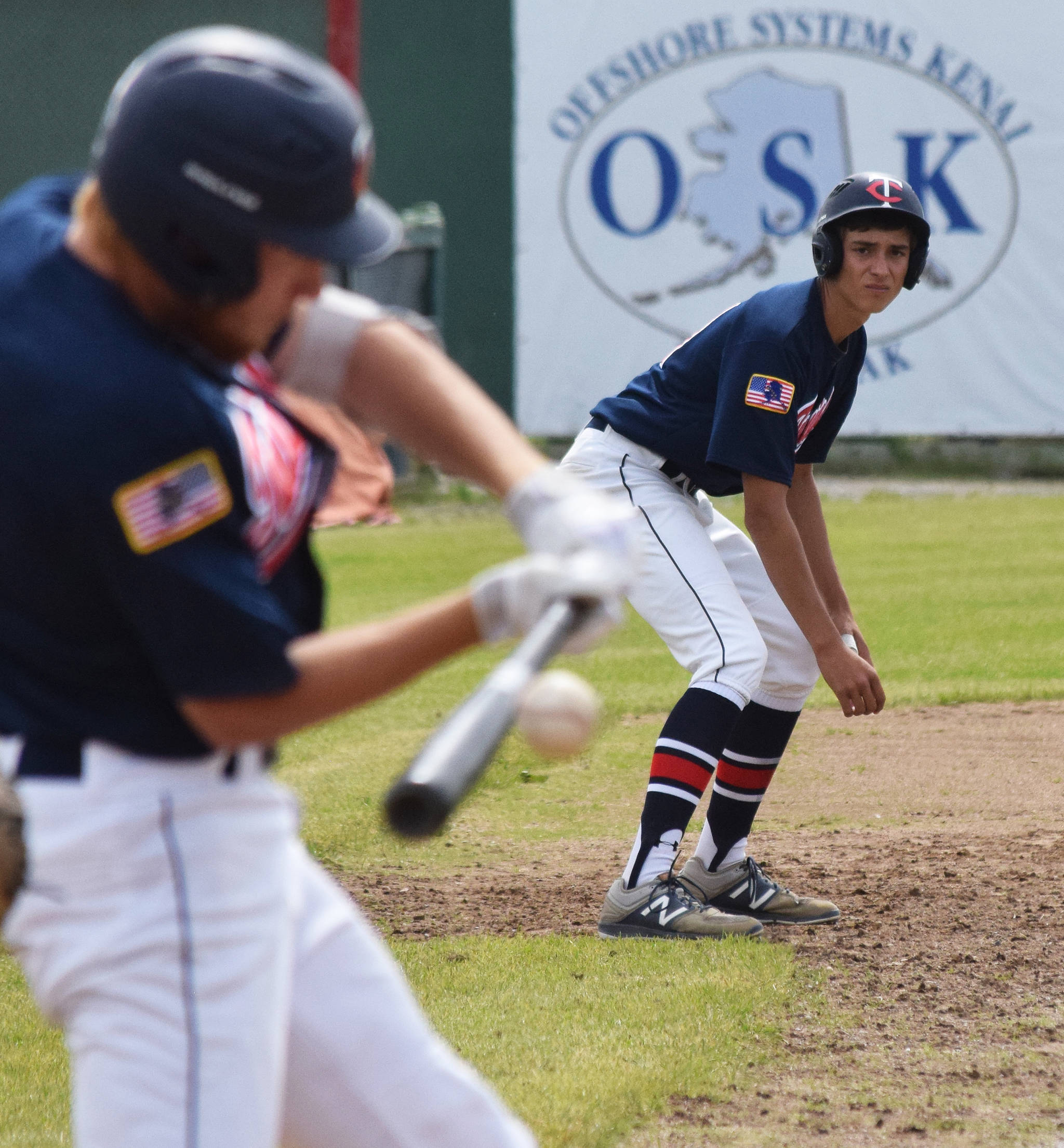 Twins pinch-runner Chris Jaime keeps an eye on teammate Jeremy Kupferschmid up to bat against the Eagle River Wolves Tuesday at the Bill Miller Big Fish Wood Bat Tournament at Coral Seymour Memorial Park in Kenai. (Photo by Joey Klecka/Peninsula Clarion